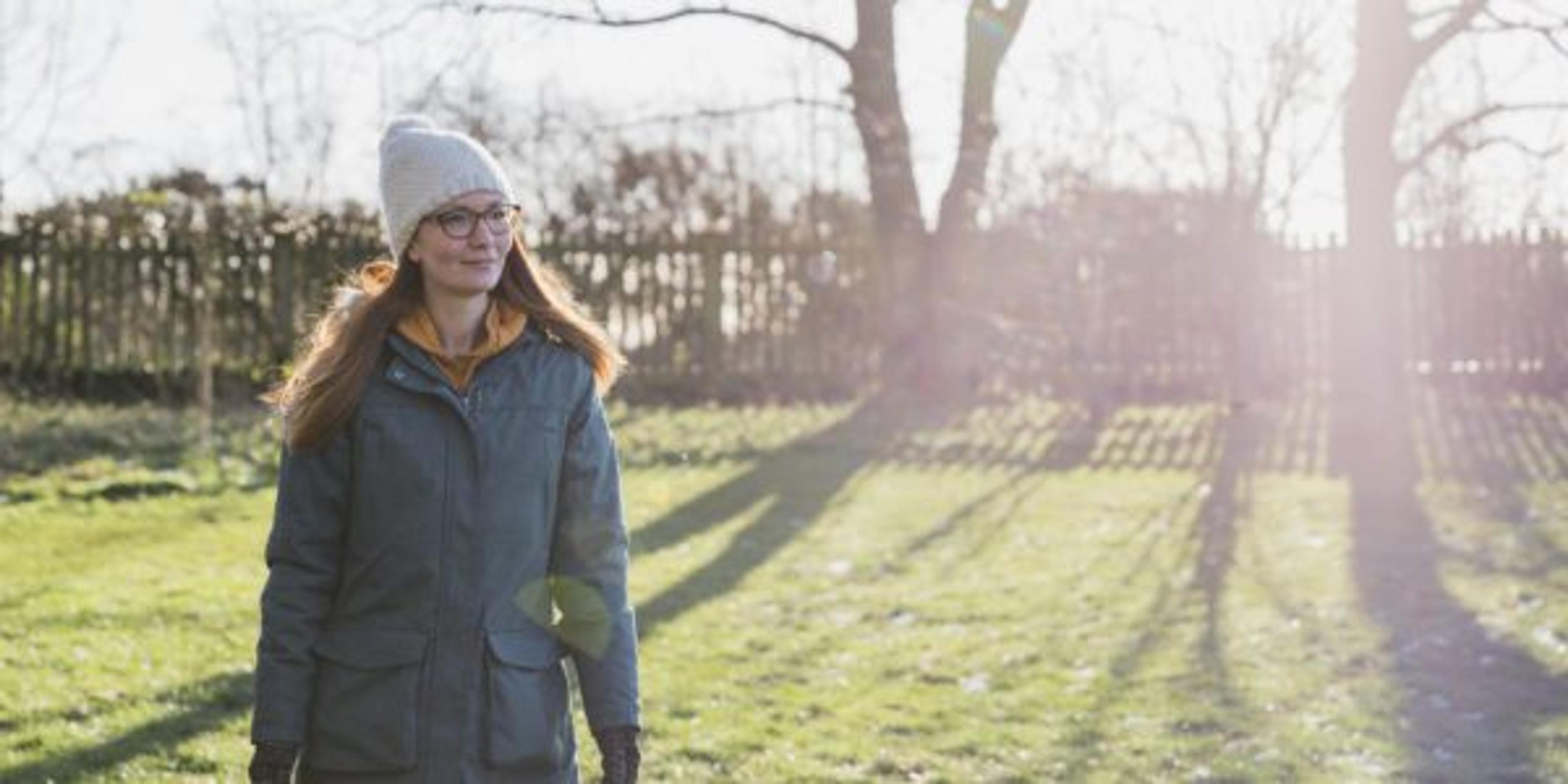 Woman walking outdoors in the sun to get vitamin D for mental health