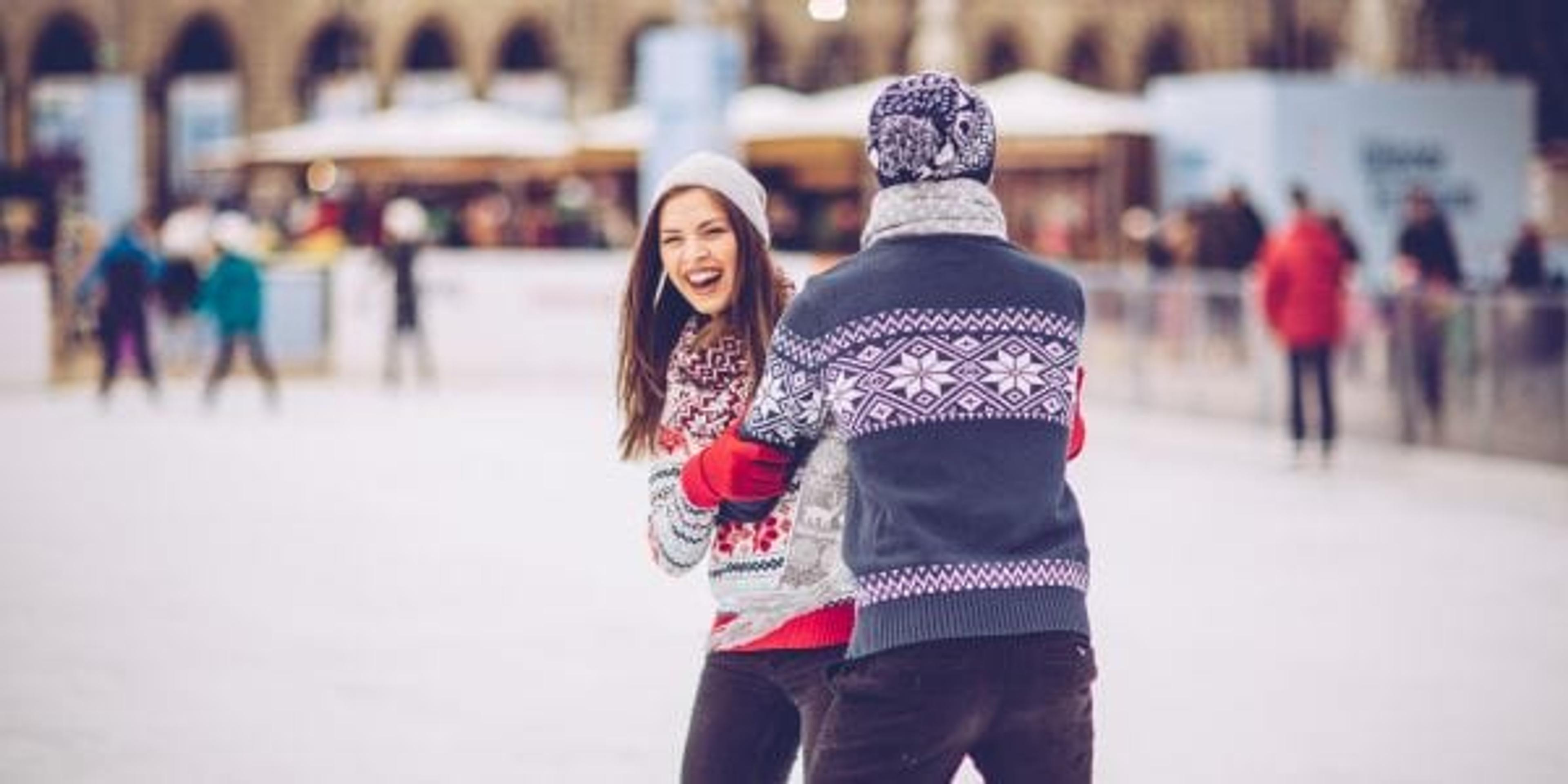 Couple having fun skating on the ice.