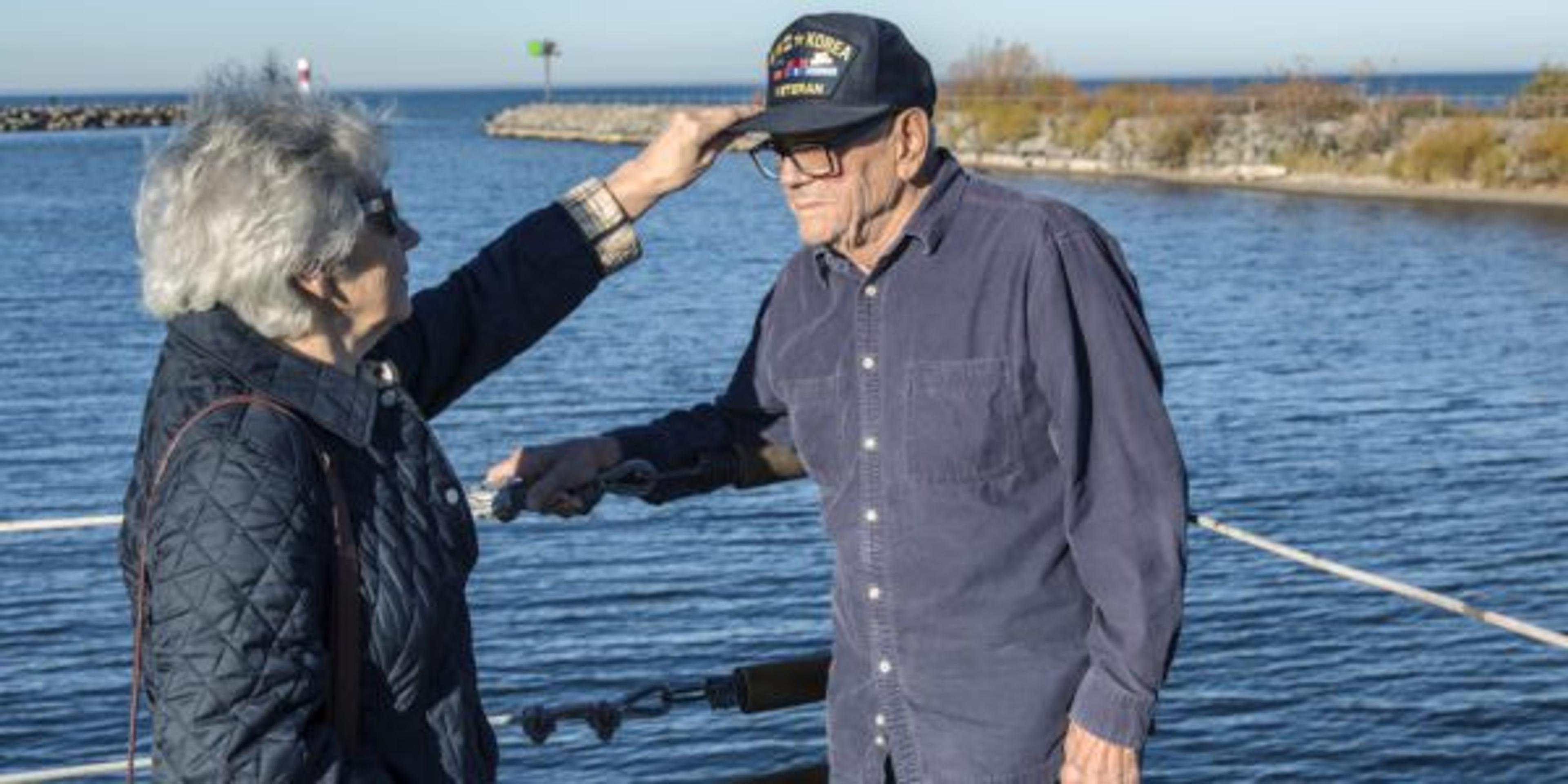 Daughter Adjusting Hat for USA WWII Military War Veteran Father