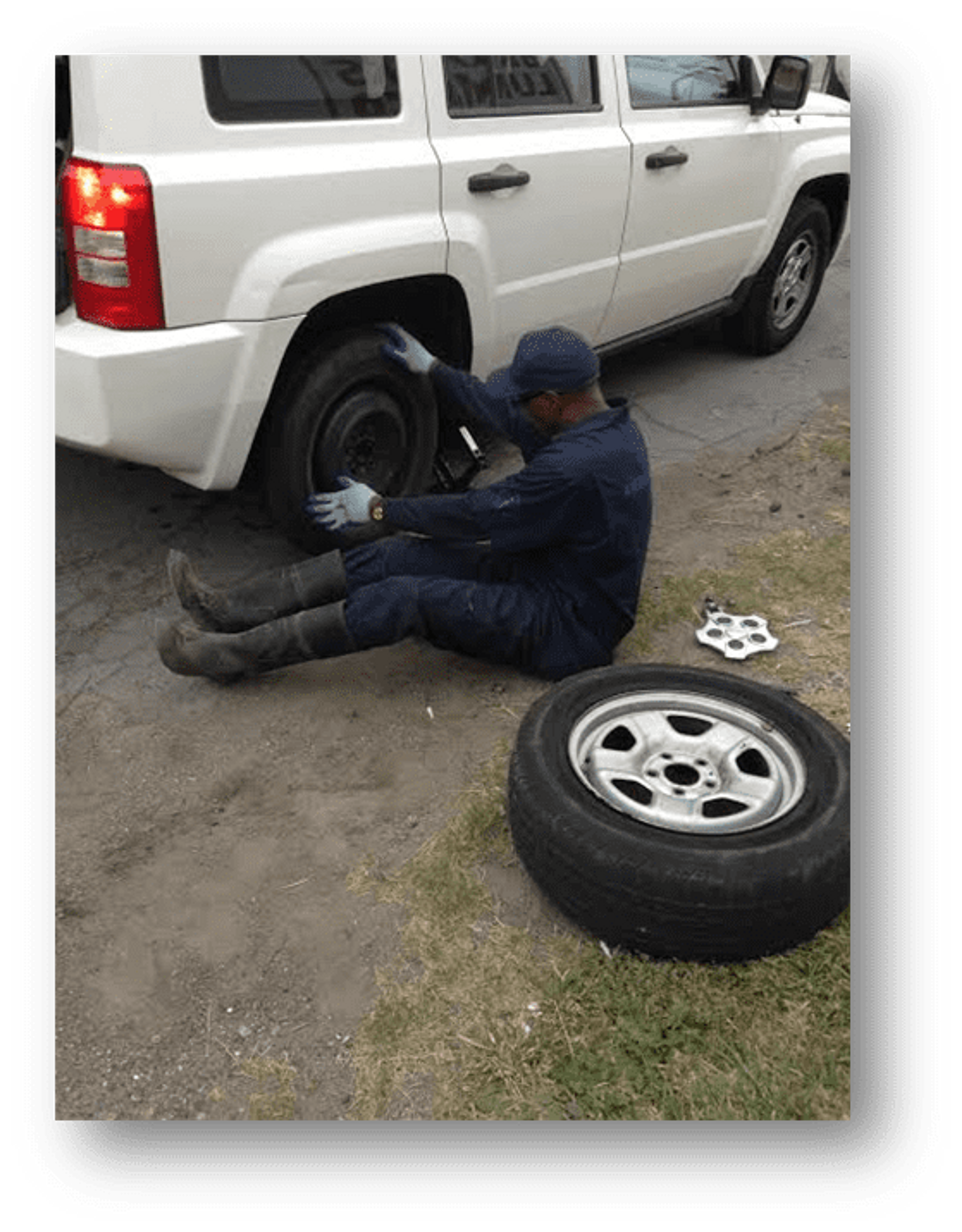 A Detroit ambassador helps change a tire.