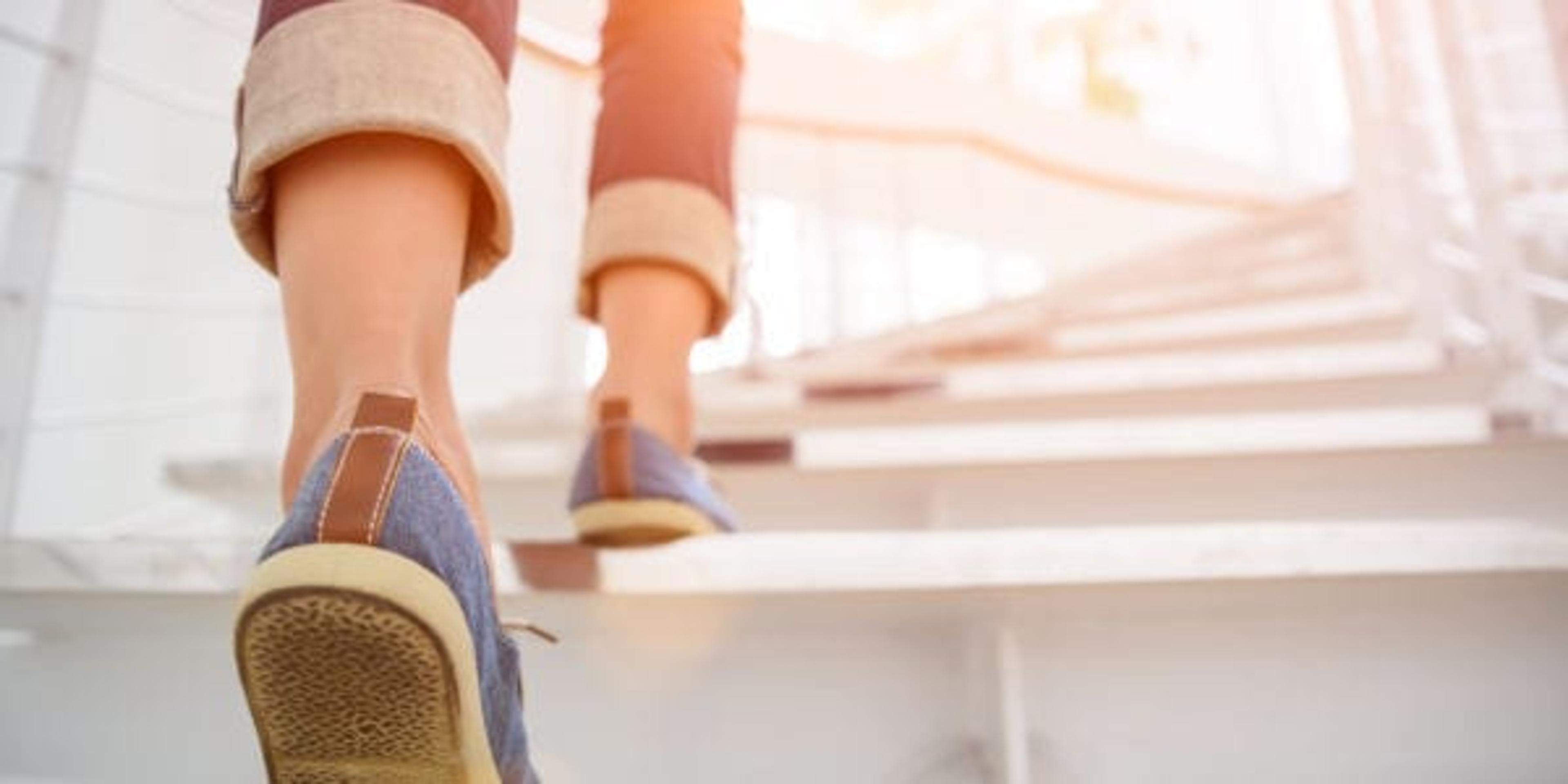 Woman walking up the stairs.