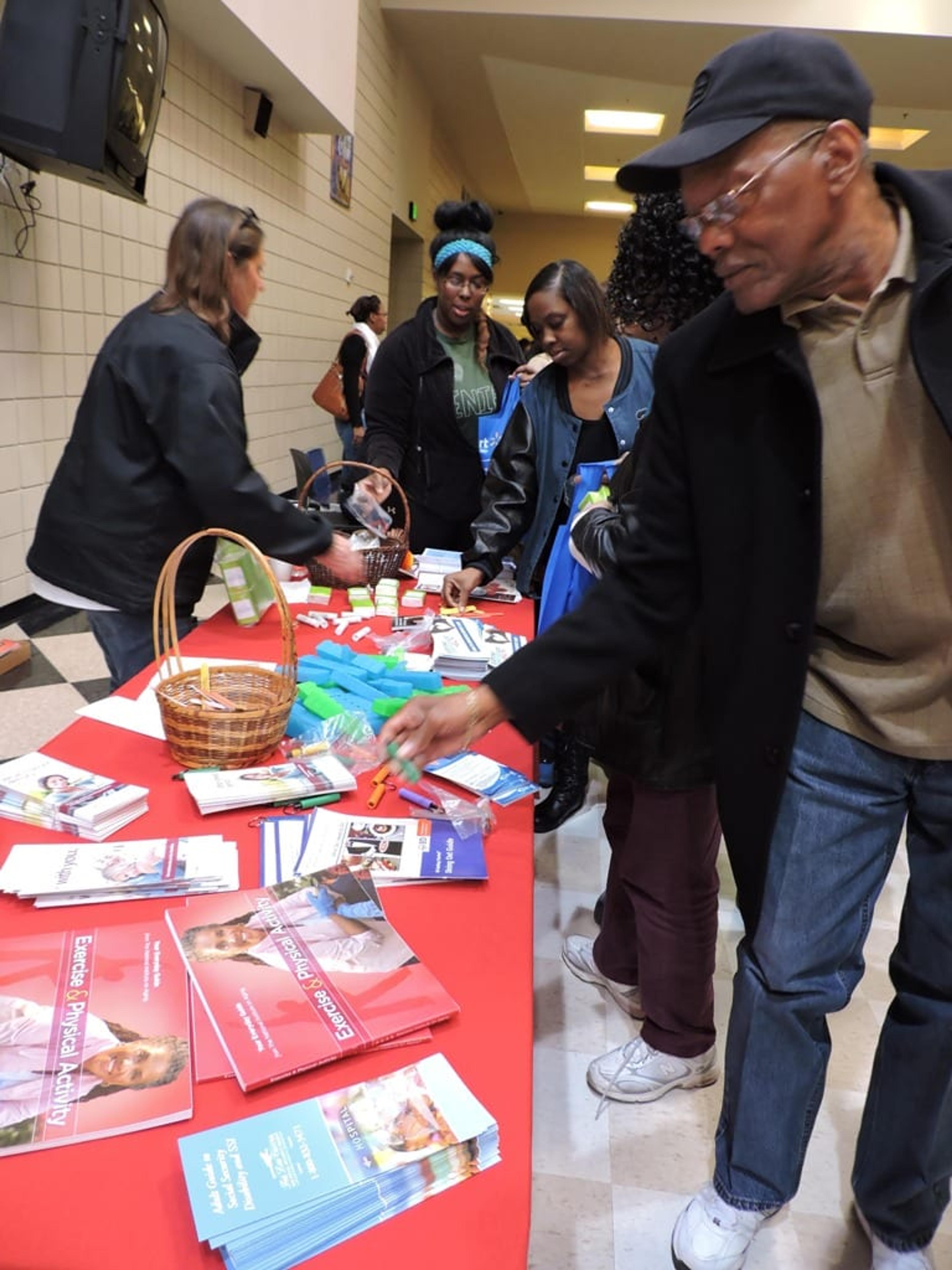 Attendees at the 11th annual African American Beating Diabetes Community Health Conference pick up literature from expo presenters.
