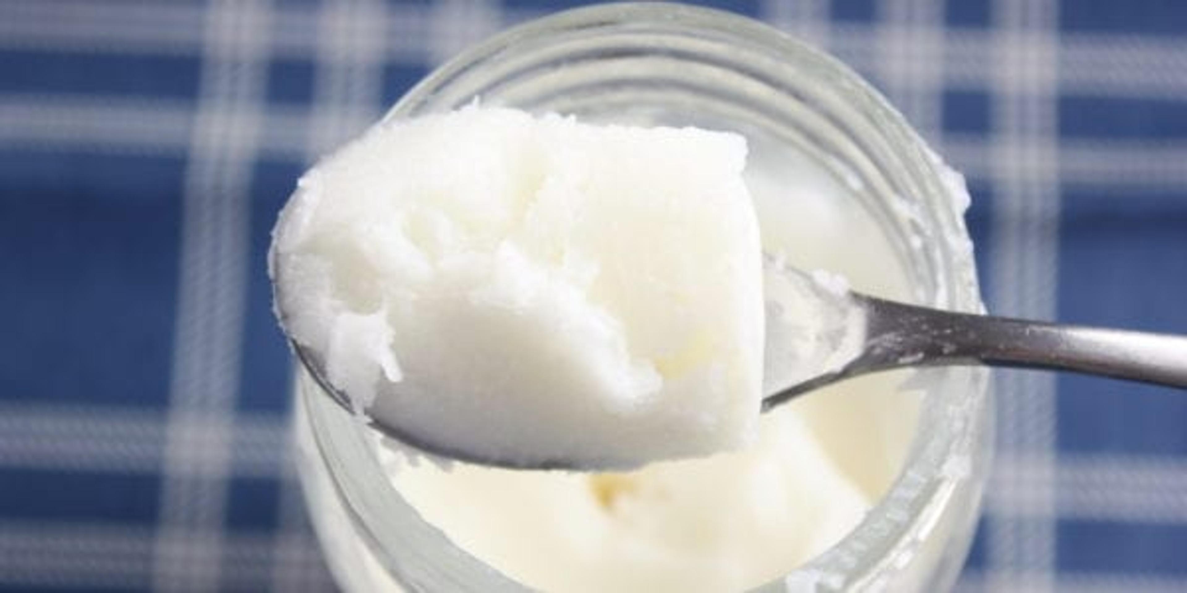 Jar and spoon of coconut oil