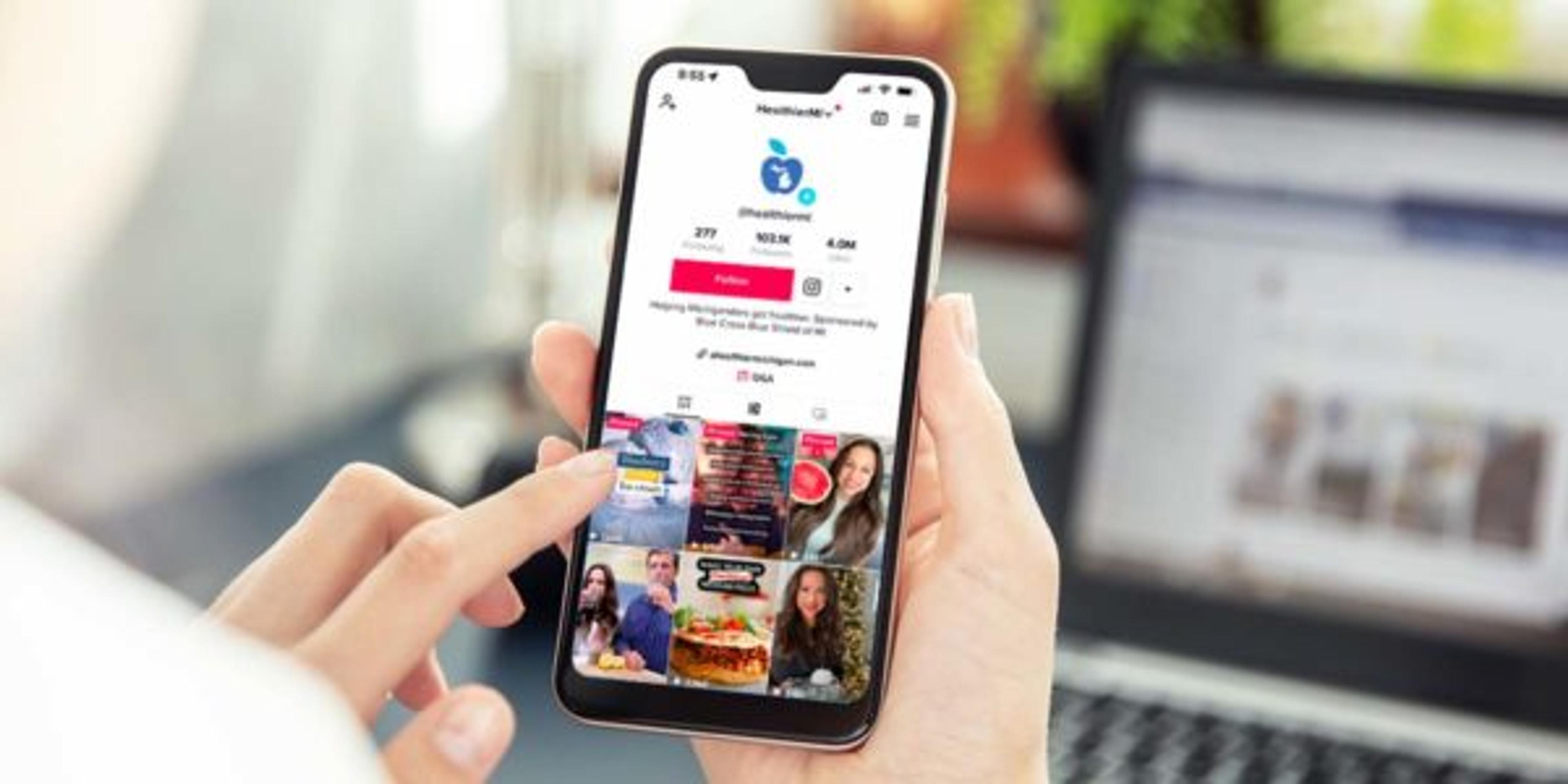 Close up a smart phone with the A Healthier Michigan TikTok channel