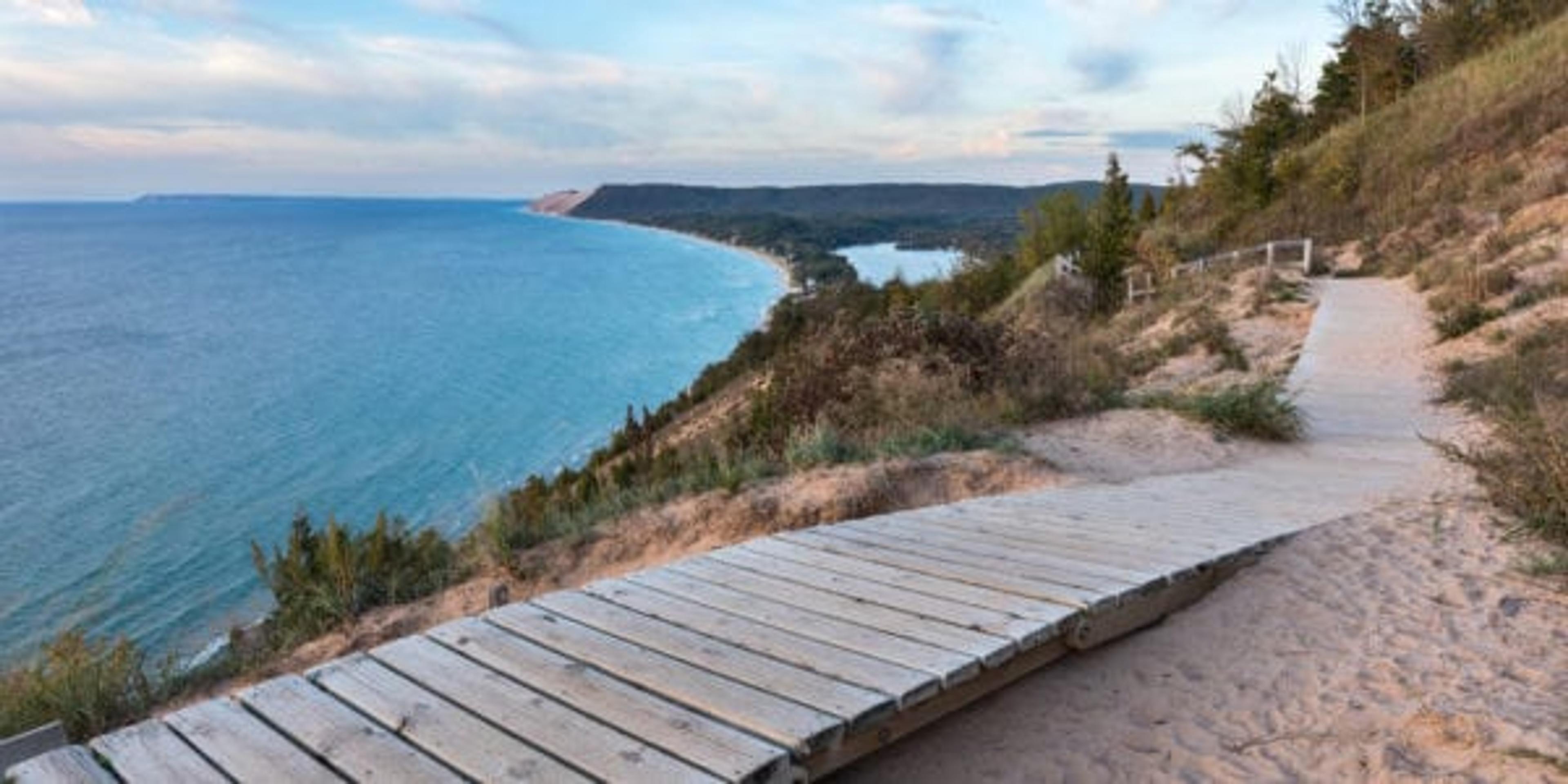 A weathered wooden walkway on the Empire Bluffs Trail is the perfect overlook to see Lake Michigan, the Sleeping Bear Dunes, and the Manitou island