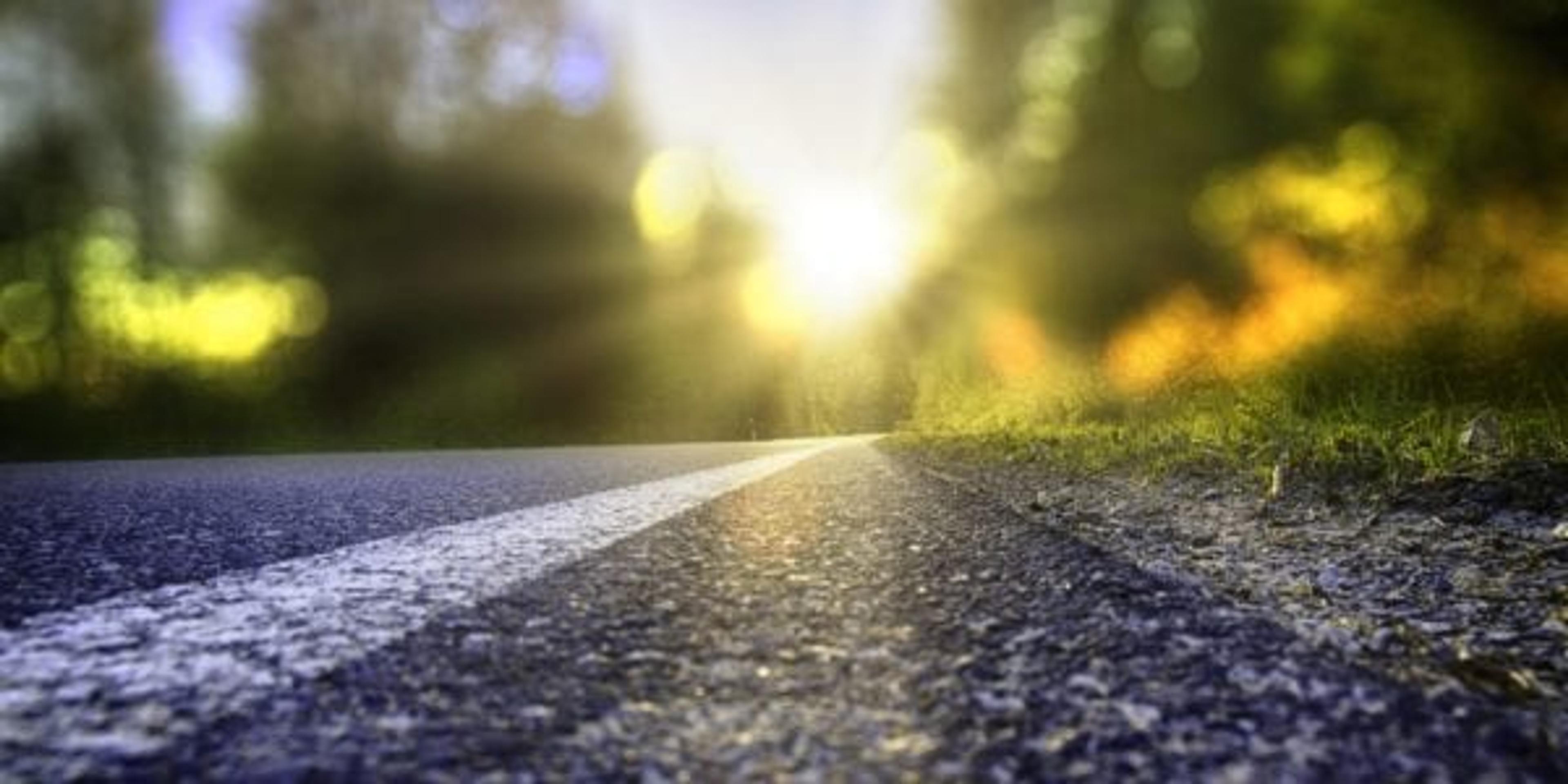 Closeup of road with beautiful scenery in background