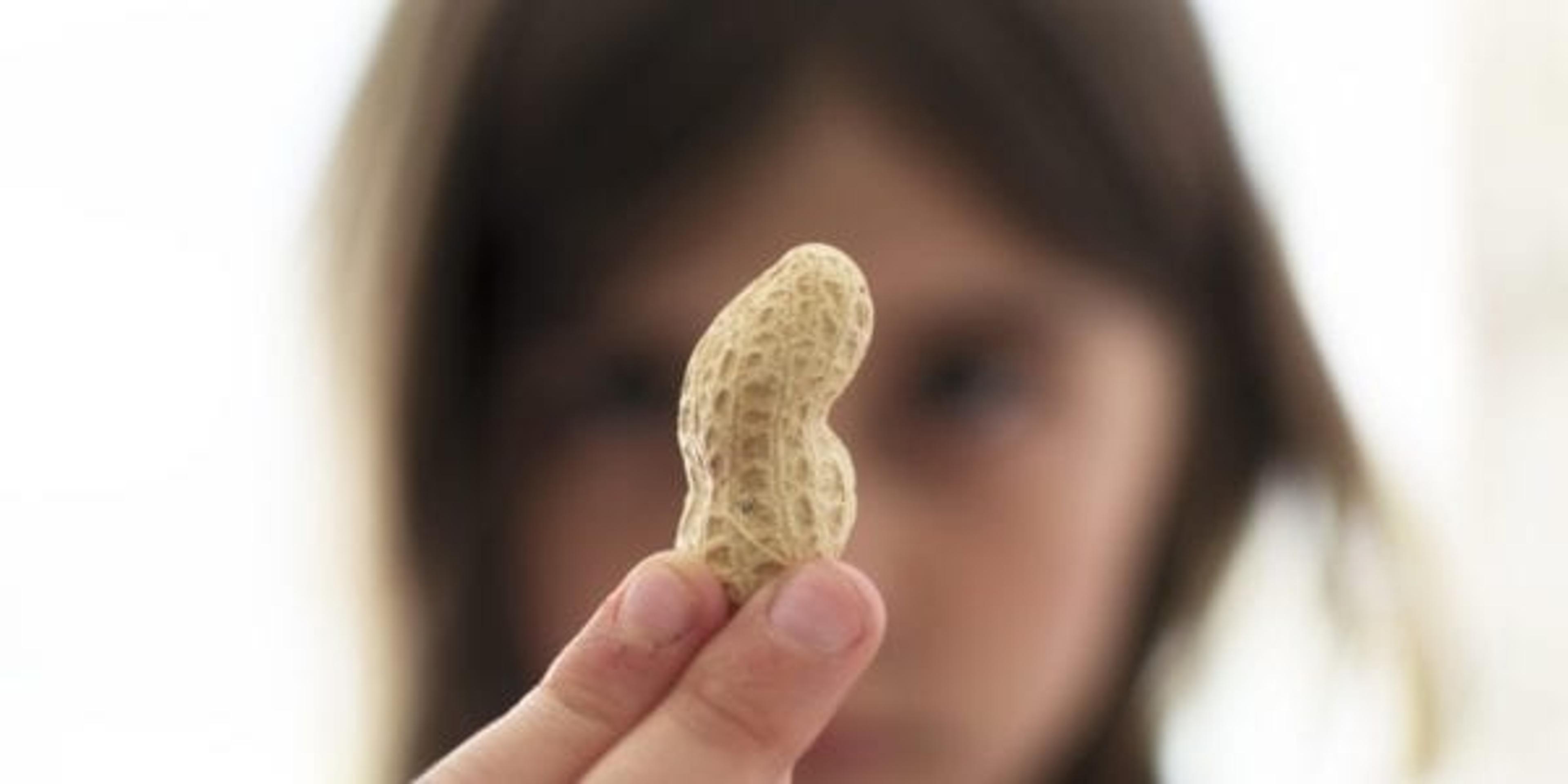 girl holding peanut