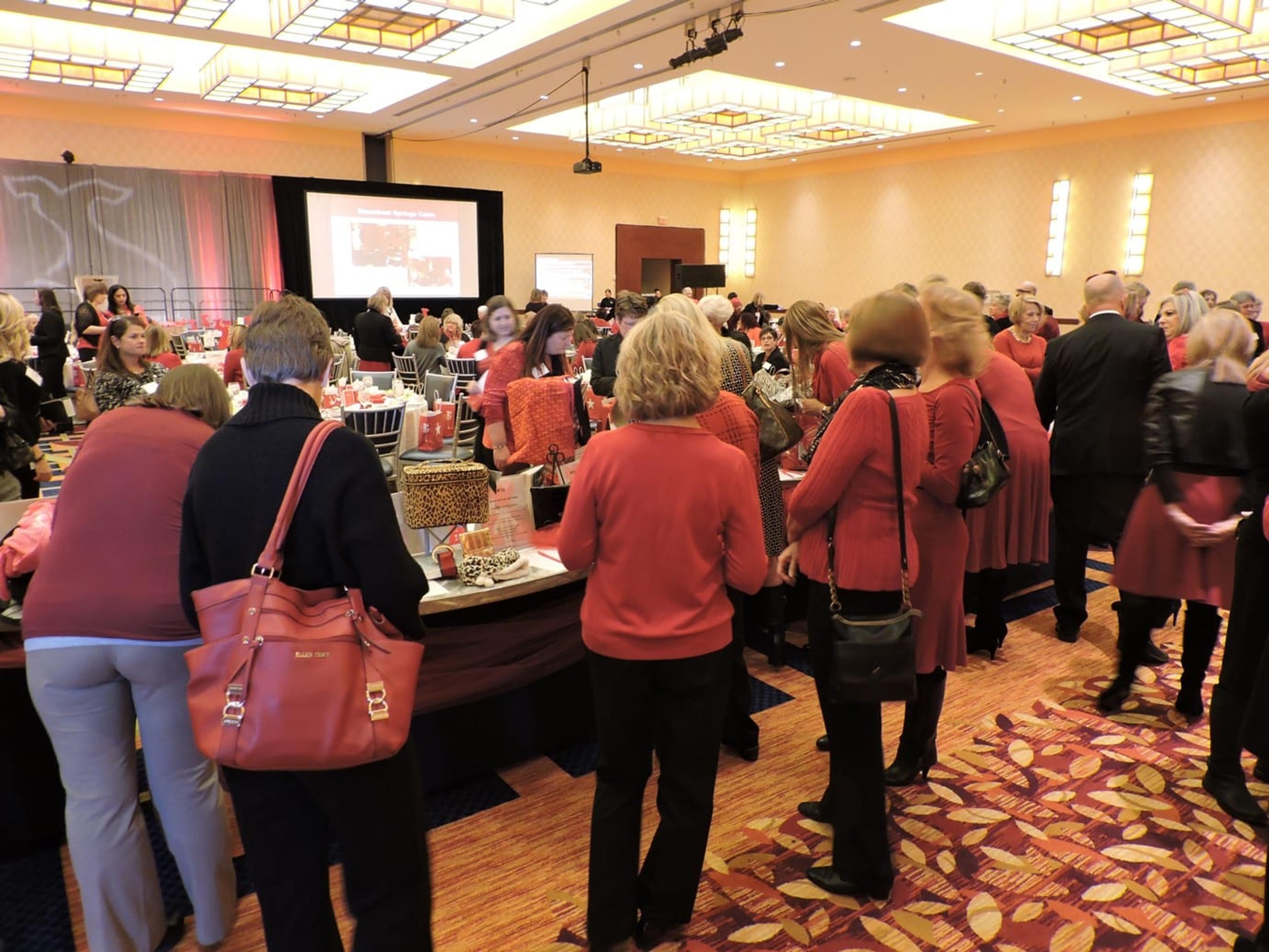 Women browsing the "Purse-inality" packages up for bid at a recent West Michigan Go Red For Women luncheon.