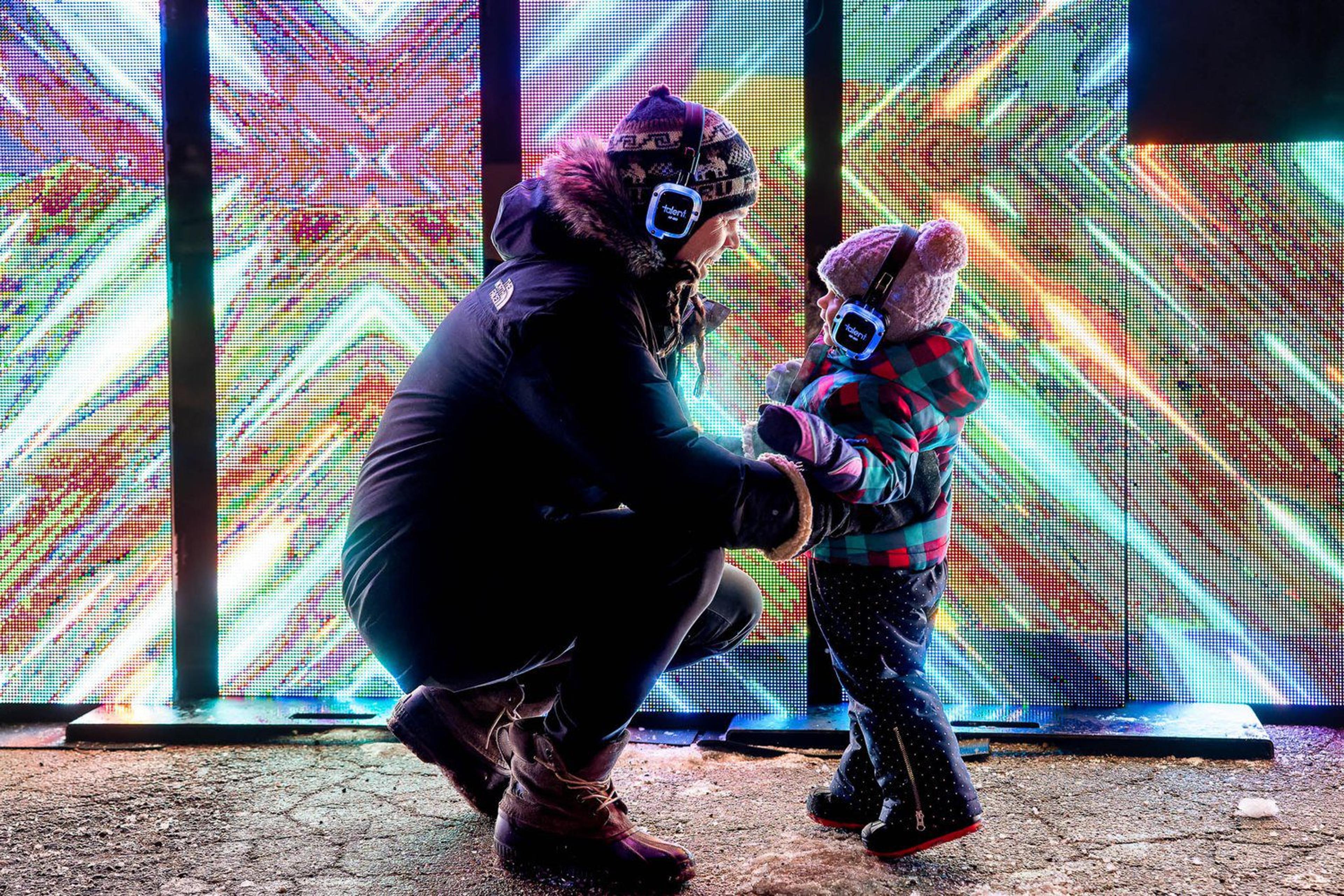 A person smiles at a small child during the Grand Rapids World of Winter festival.