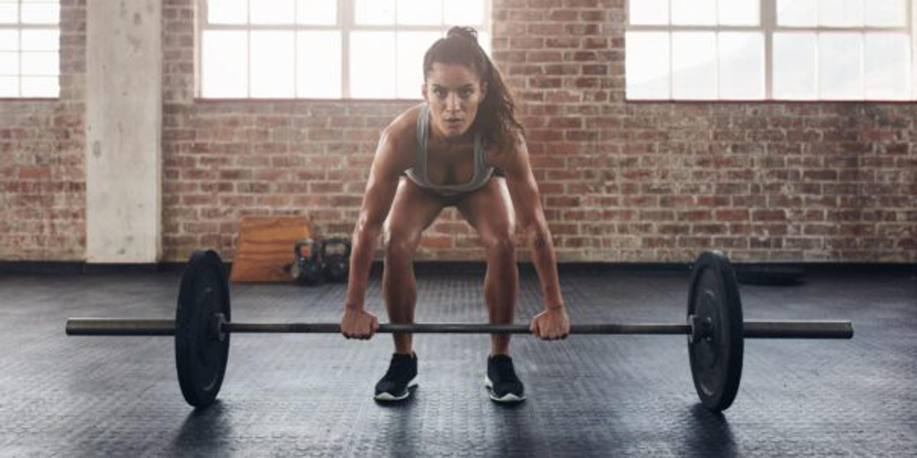 Woman with a heavy weight doing a dead lift