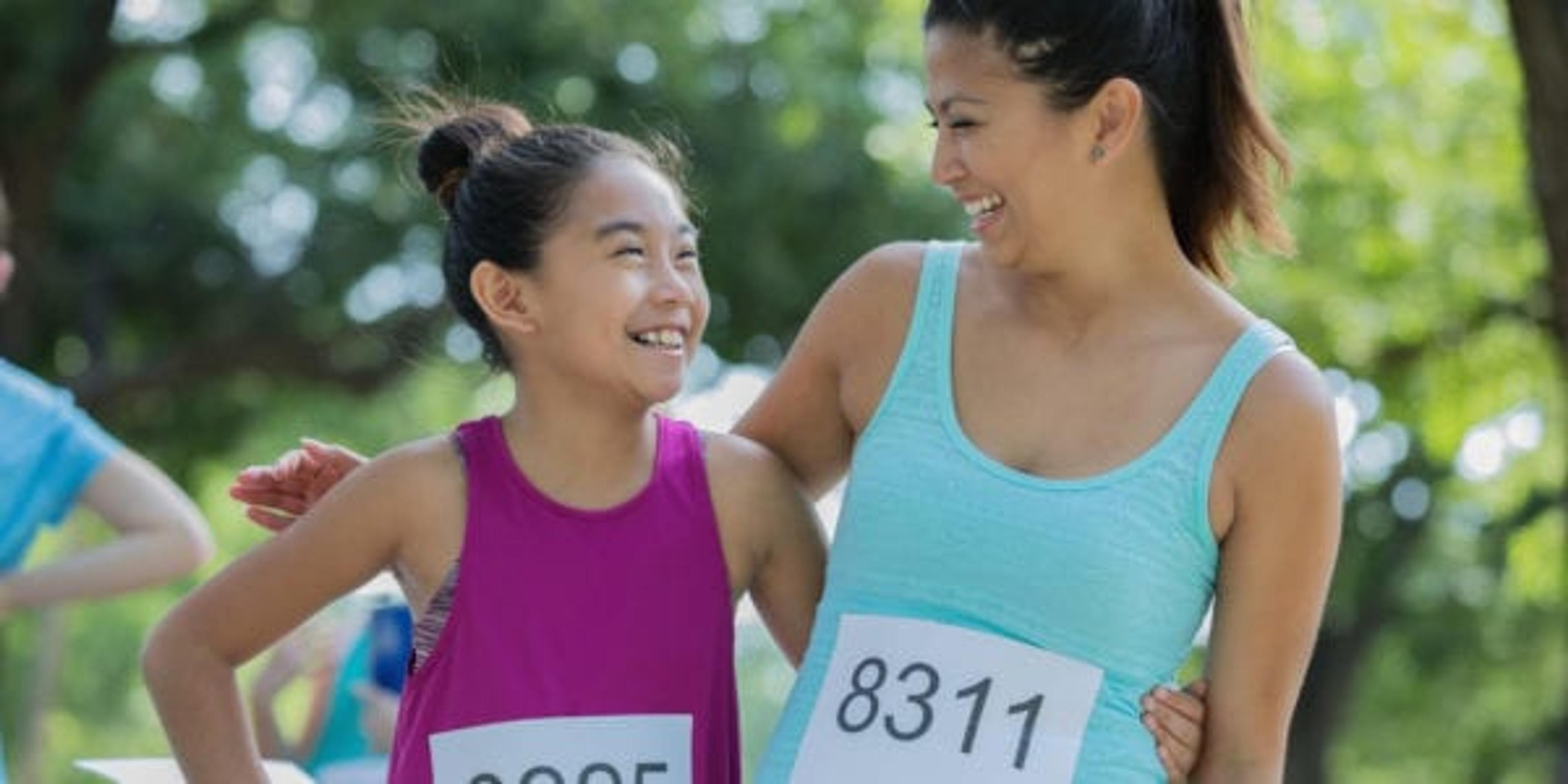 Mom and daughter finishing a race together