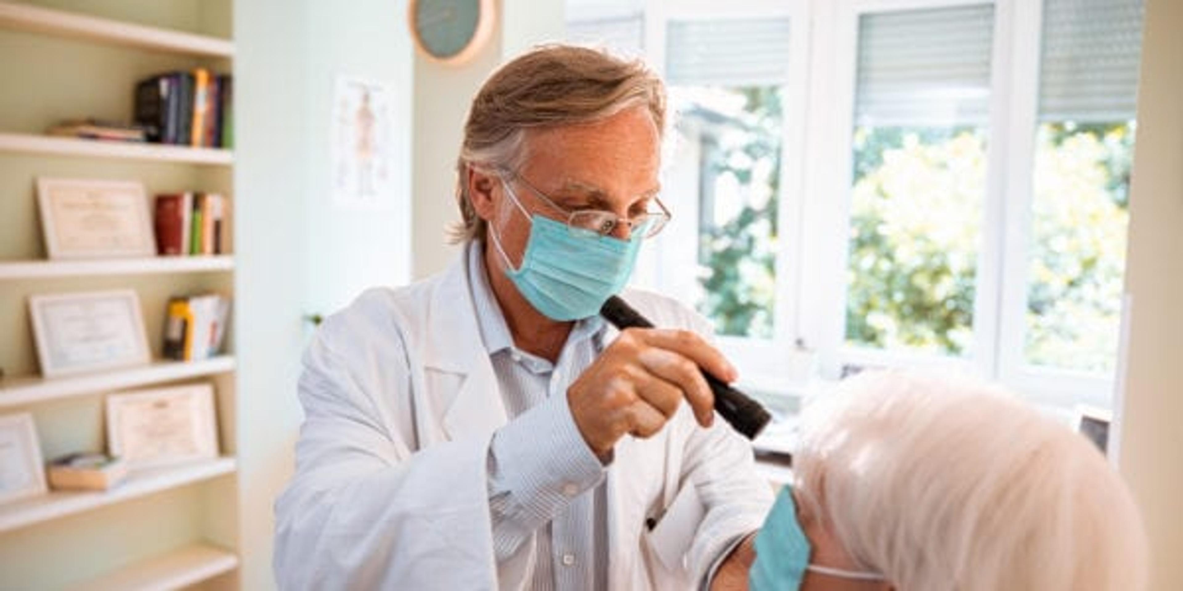 Close up of a doctor doing an eye exam on his patient