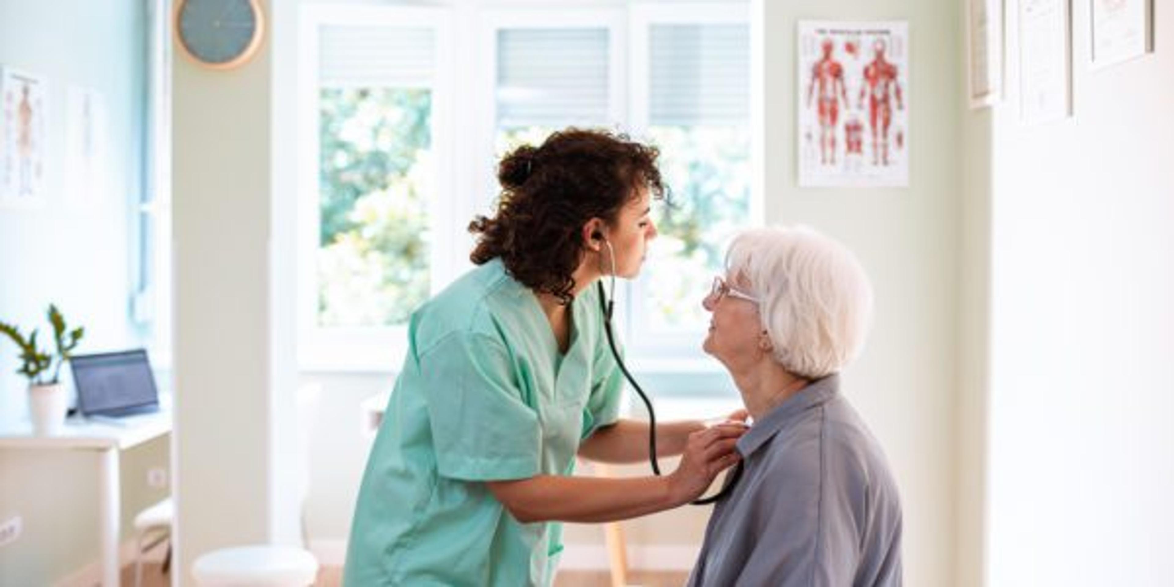 A woman has her lungs checked by a doctor.