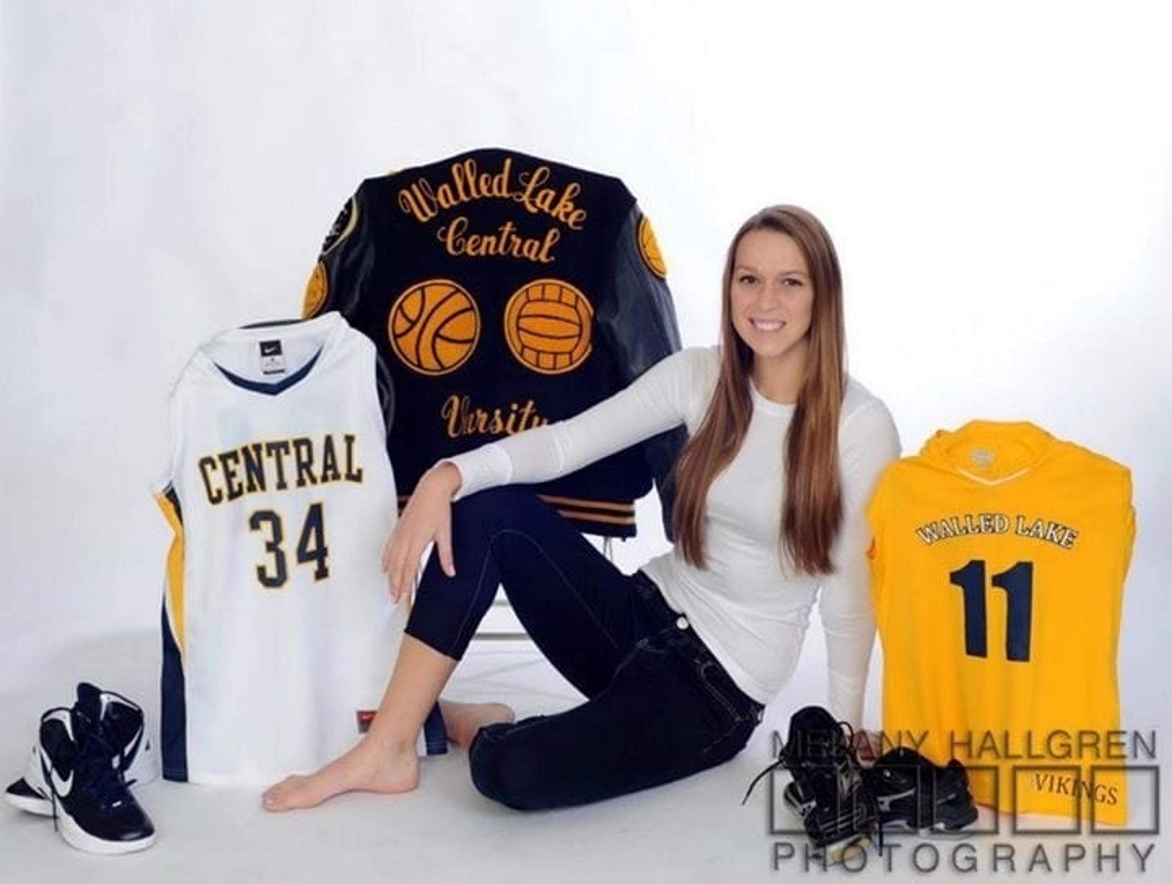 Katelynn sitting with volleyball jerseys