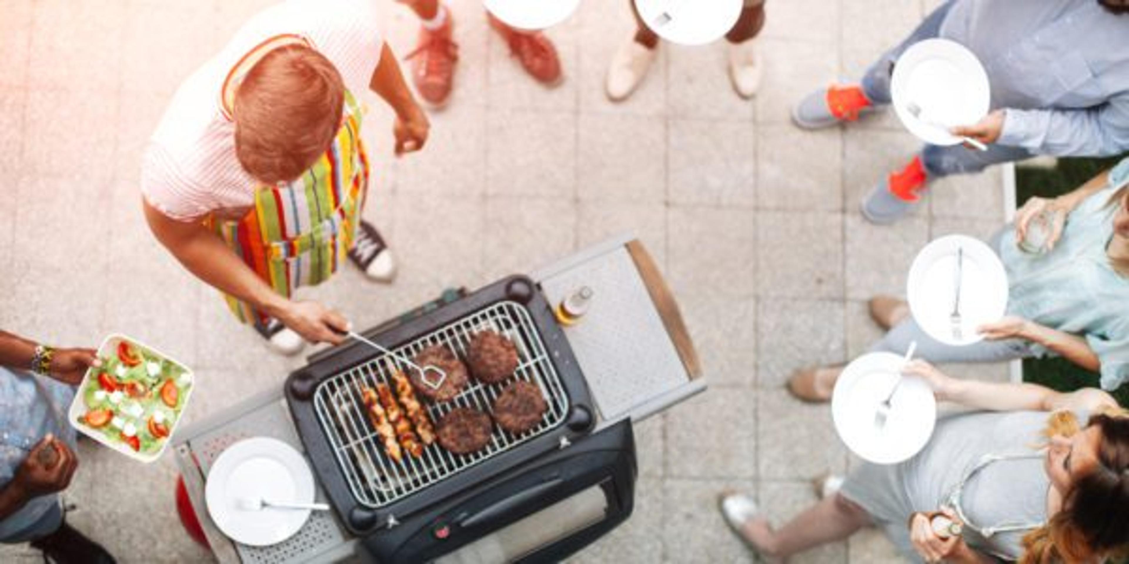 Young People Having Fun At Barbecue Party.