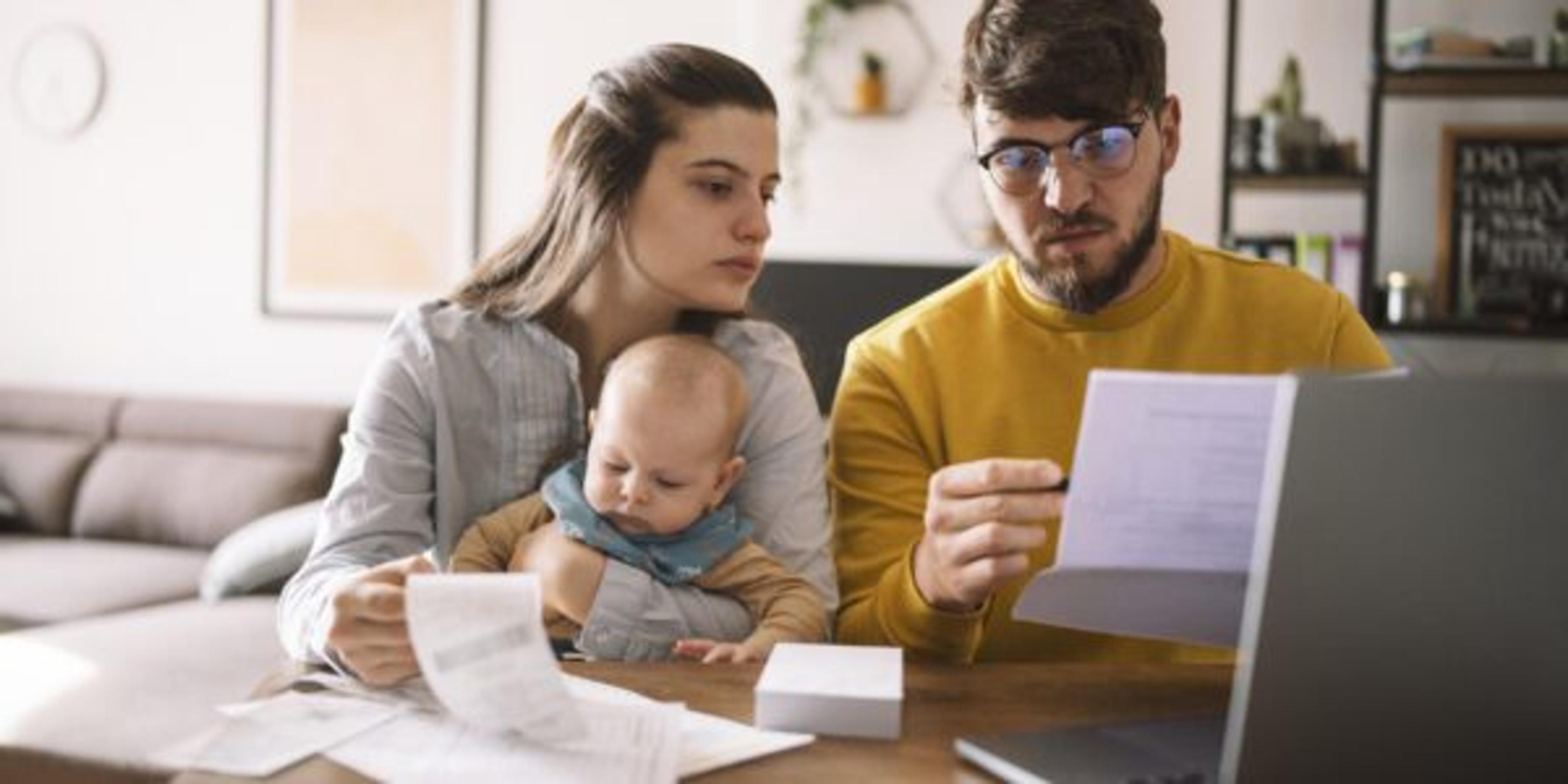 Young family managing budget and paying bills and taxes.