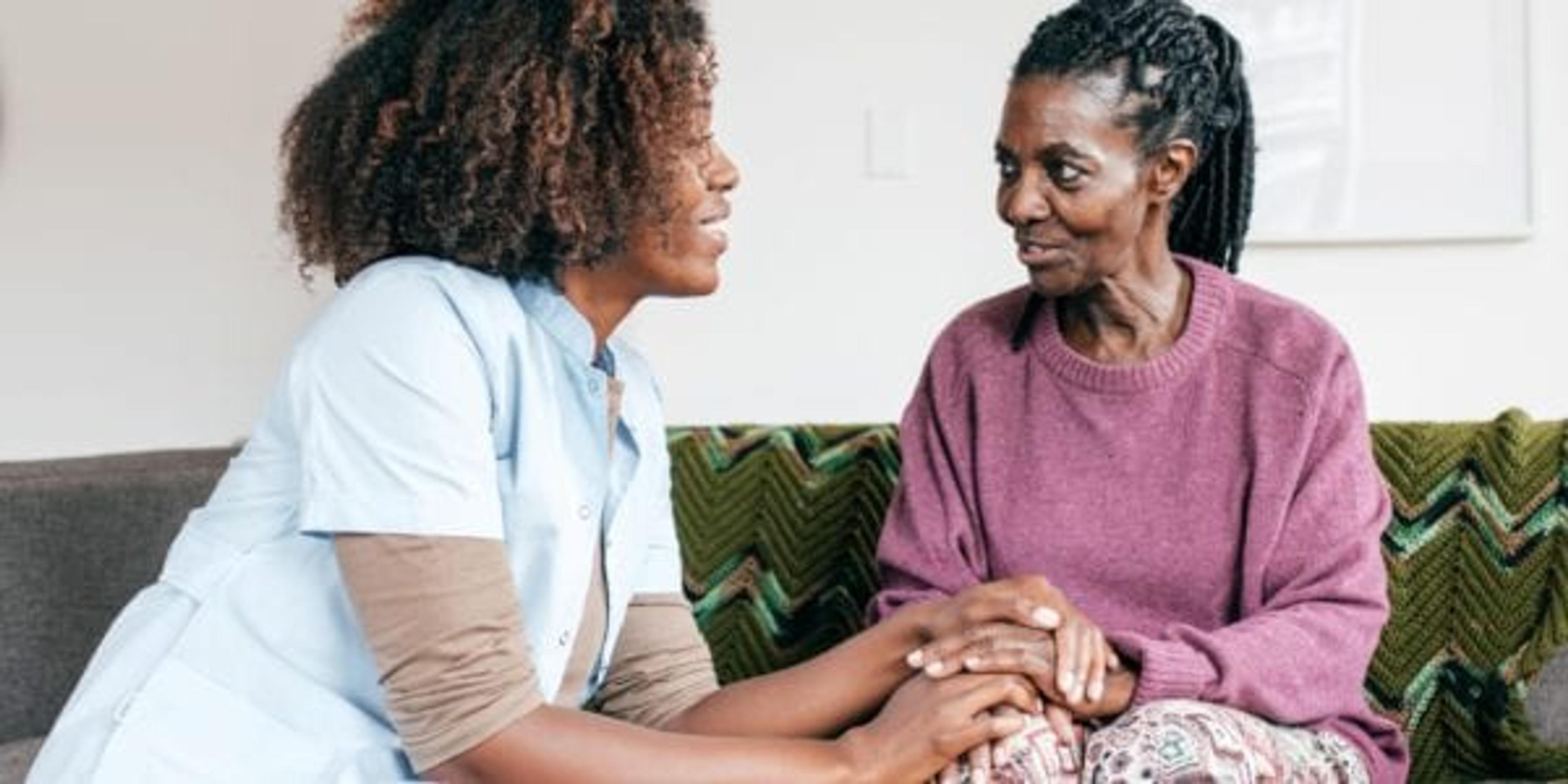 Senior lady and caregiver talking together