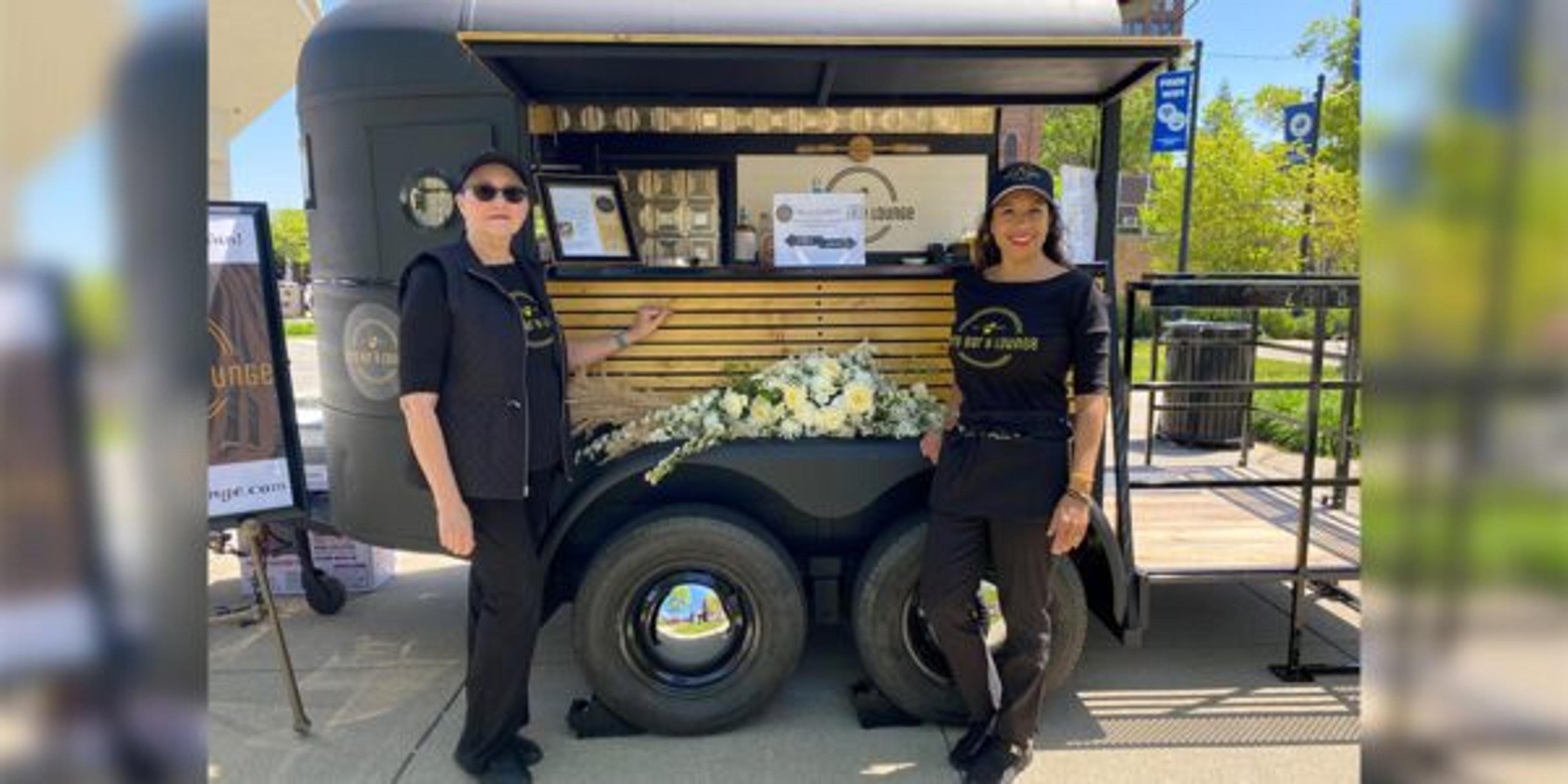 Jackson’s Zero Bar & Lounge owners pose for a photo in front of their new mobile bar.