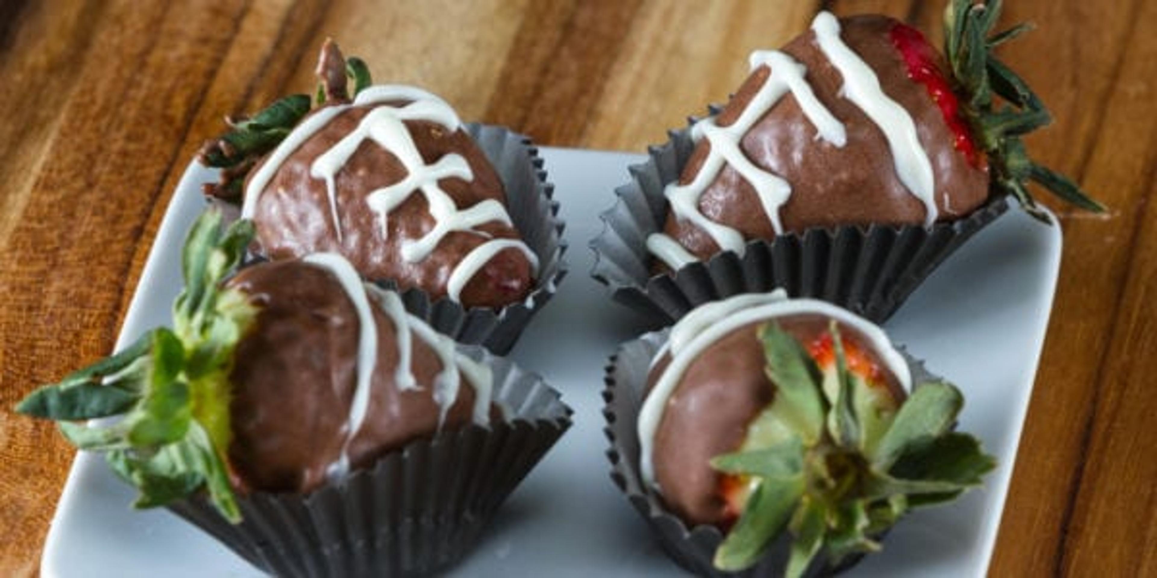 image of chocolate covered strawberries made to look like footballs