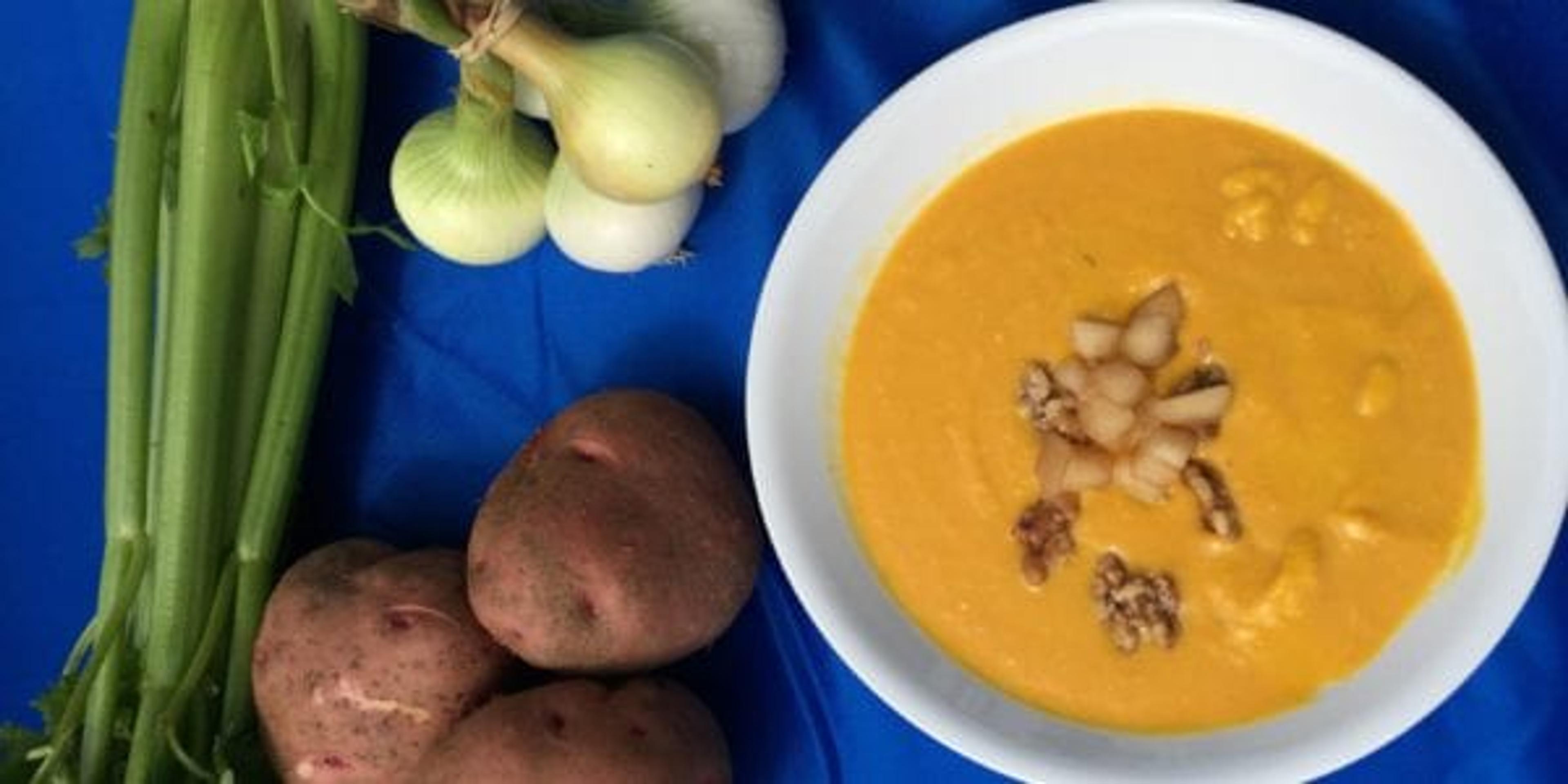 Bowl of soup with vegetables on a table