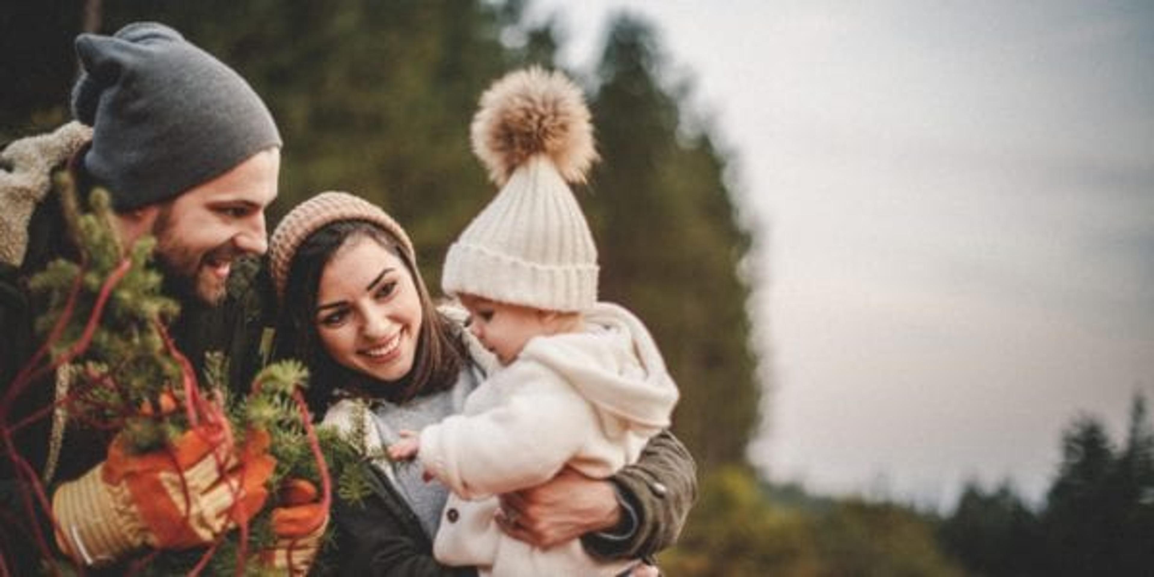 Parents and daughter picking out decorations