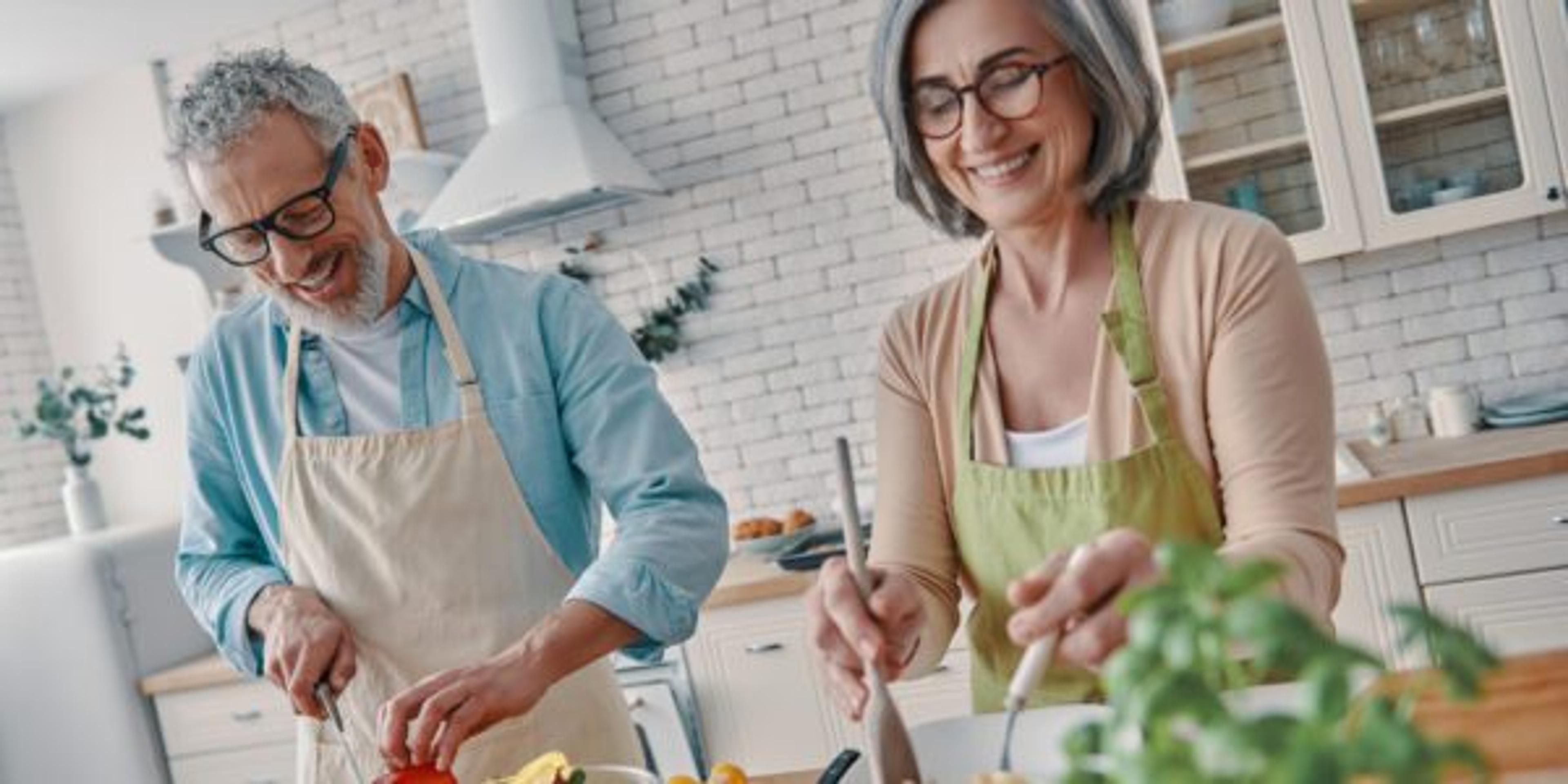 Happy senior couple making dinner