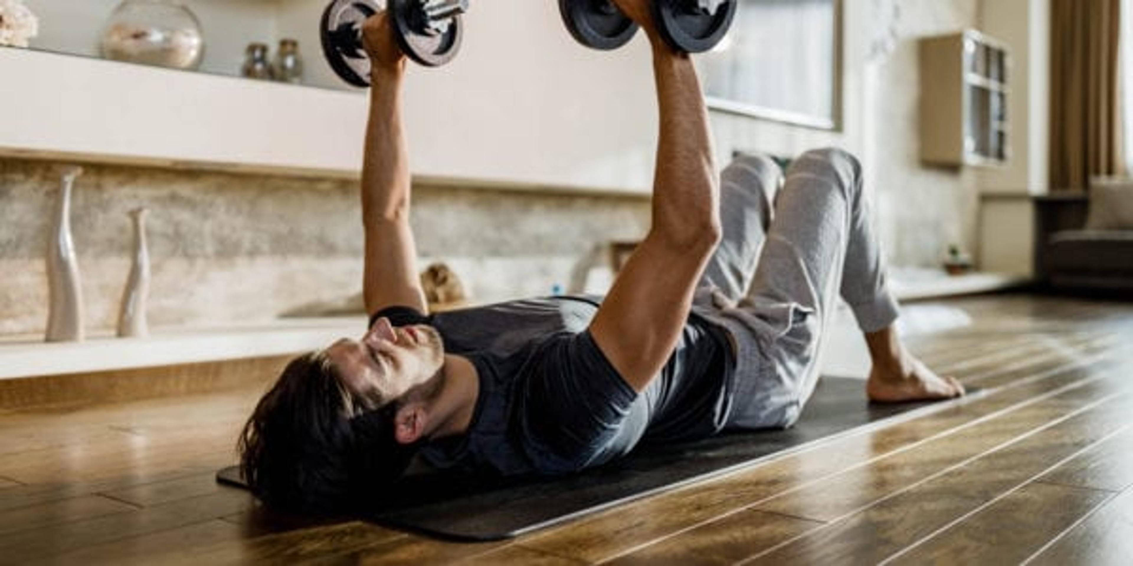 Man lifting weights in his living room