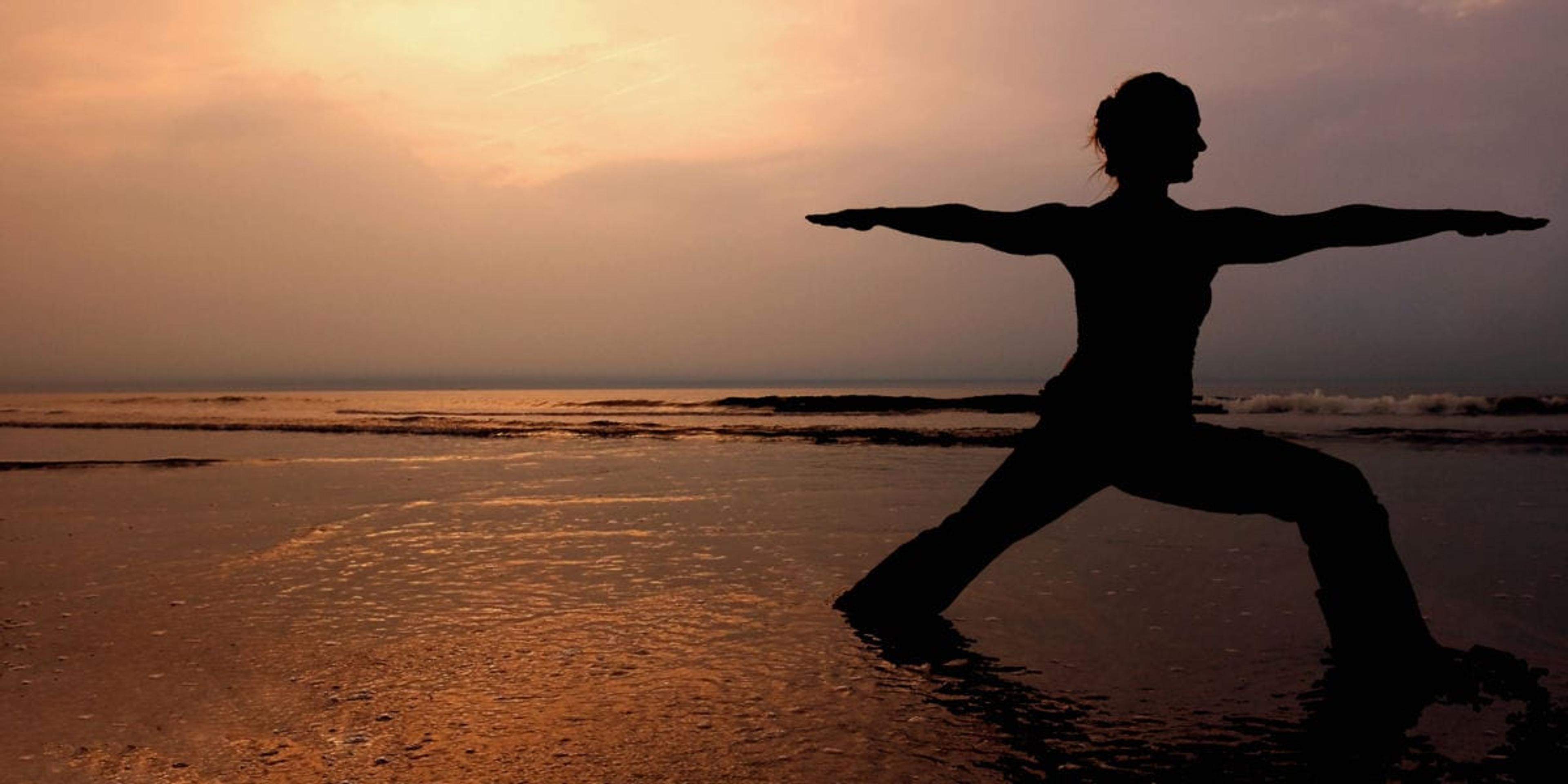 yoga on the beach at sunset
