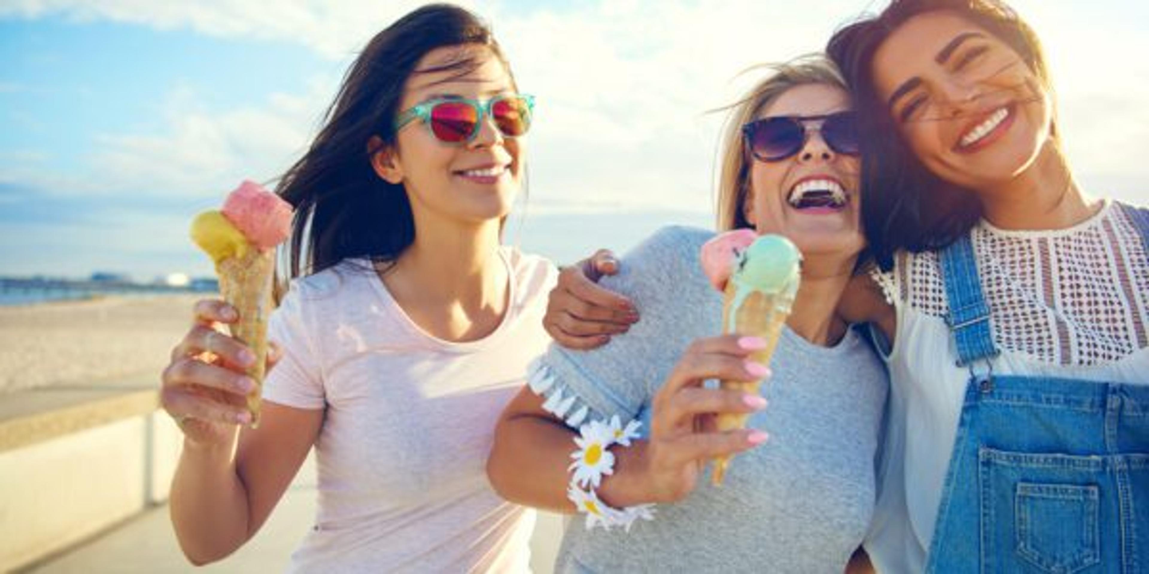 Laughing teenage girls enjoying ice cream cones