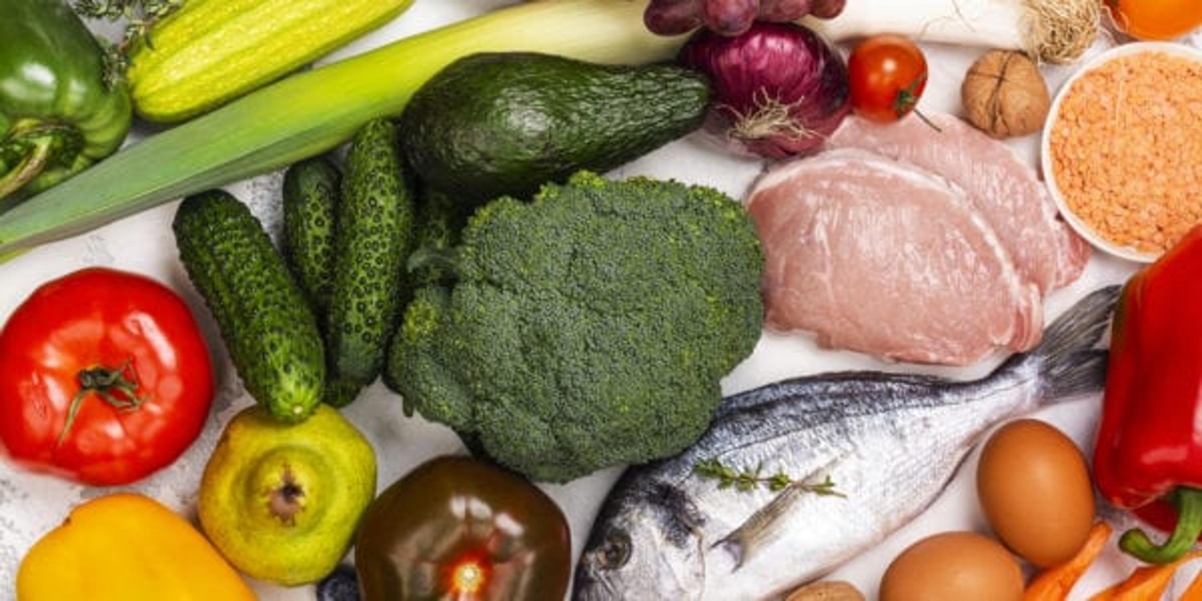 Pegan diet products on white stone background. Healthy eating concept paleo plus vegan approach