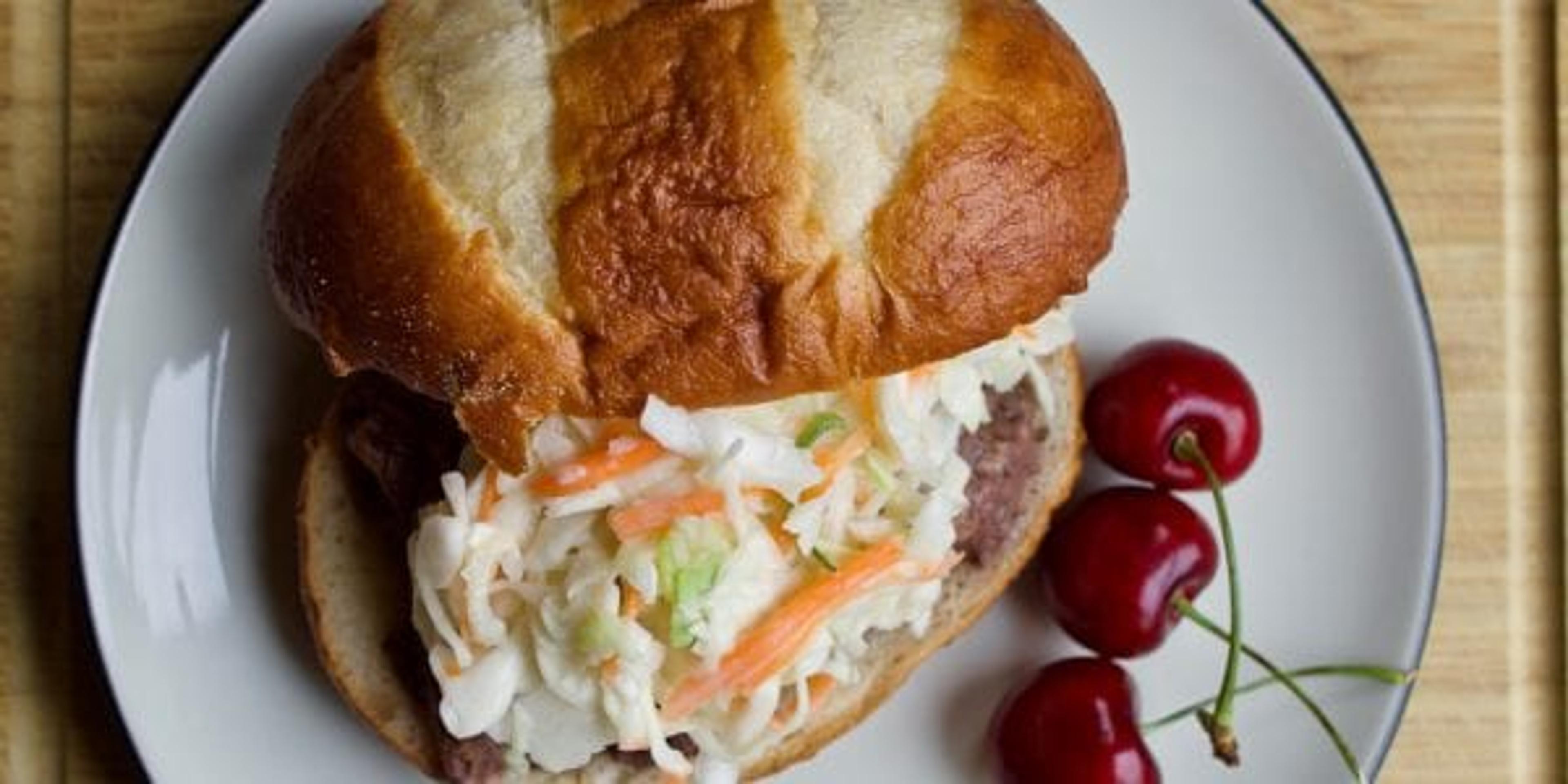 slow cooker cherry beef carnitas with pretzel bun