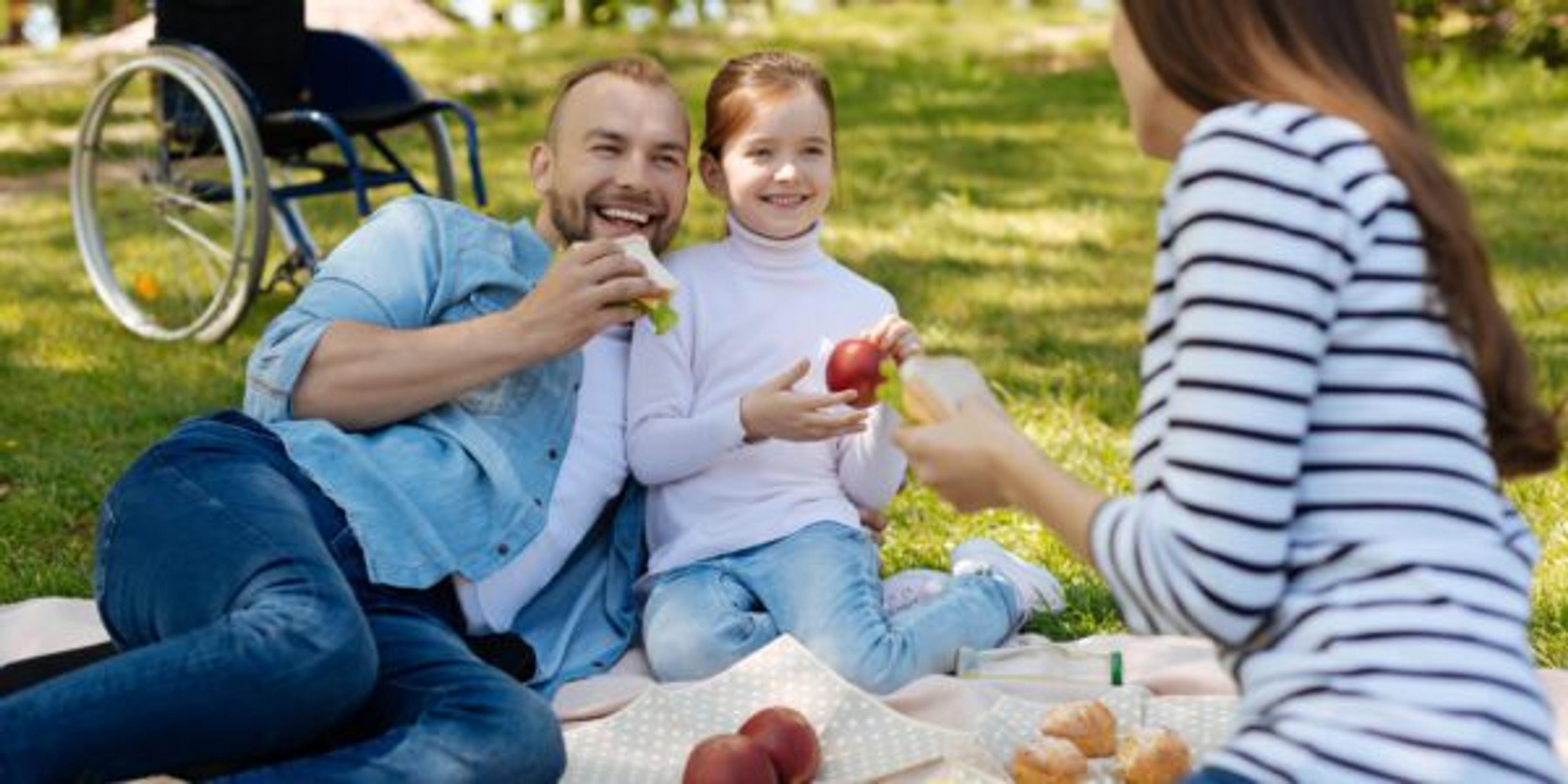 Delighted man spending time on the picnic