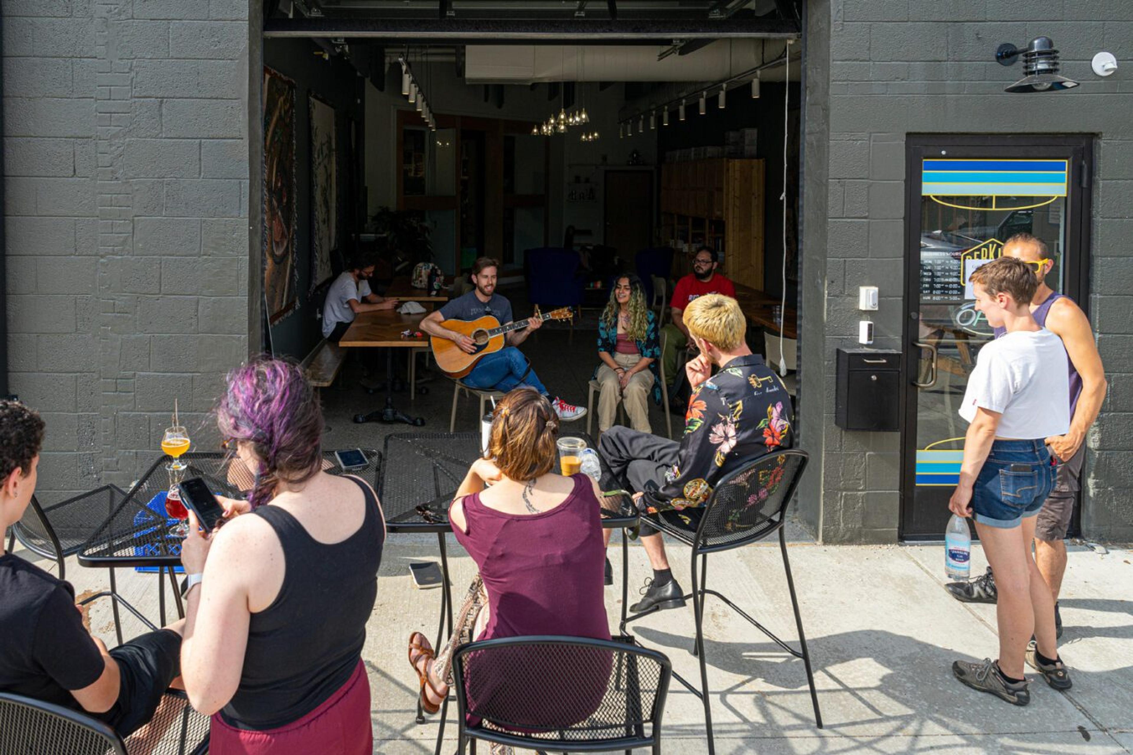 Customers gather outside to talk, laugh, drink and watch live music.