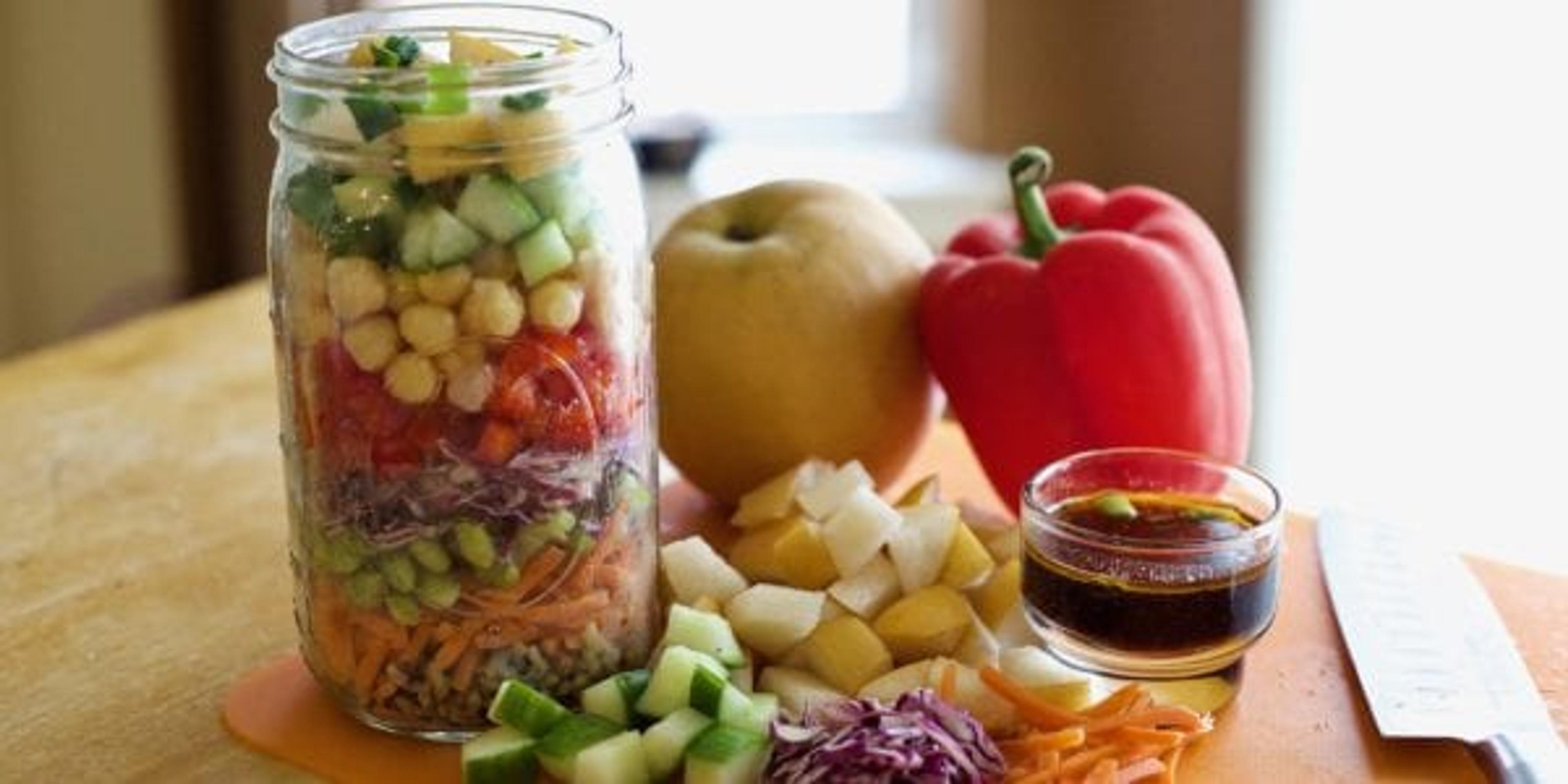 Mason jar filled with vegetables on table