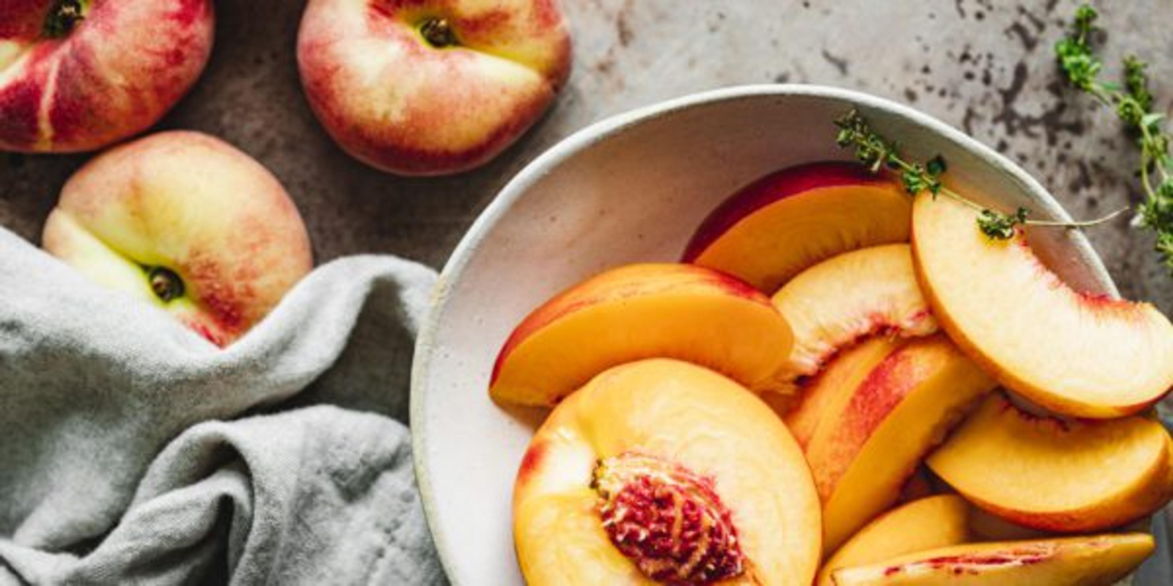 Slices of ripe peaches in a bowl.