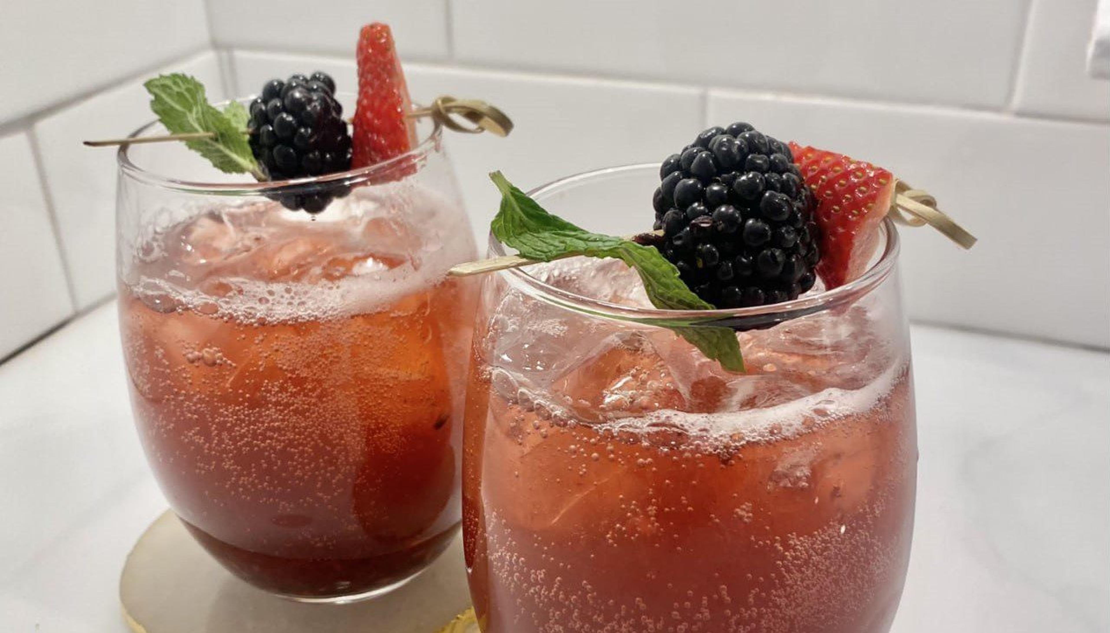 Muddled strawberry blackberry mint mocktail.