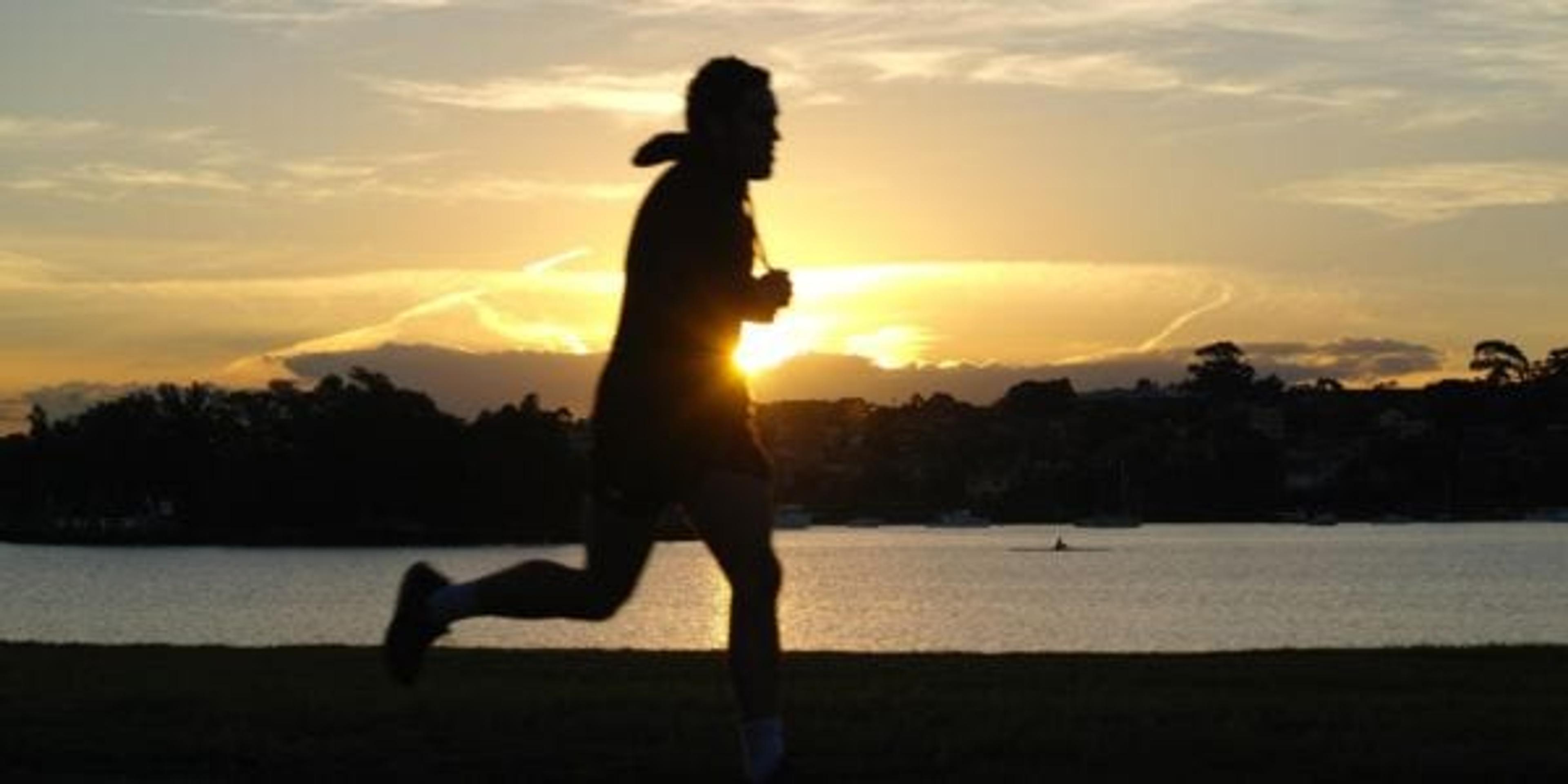 silhouette runner on a beach