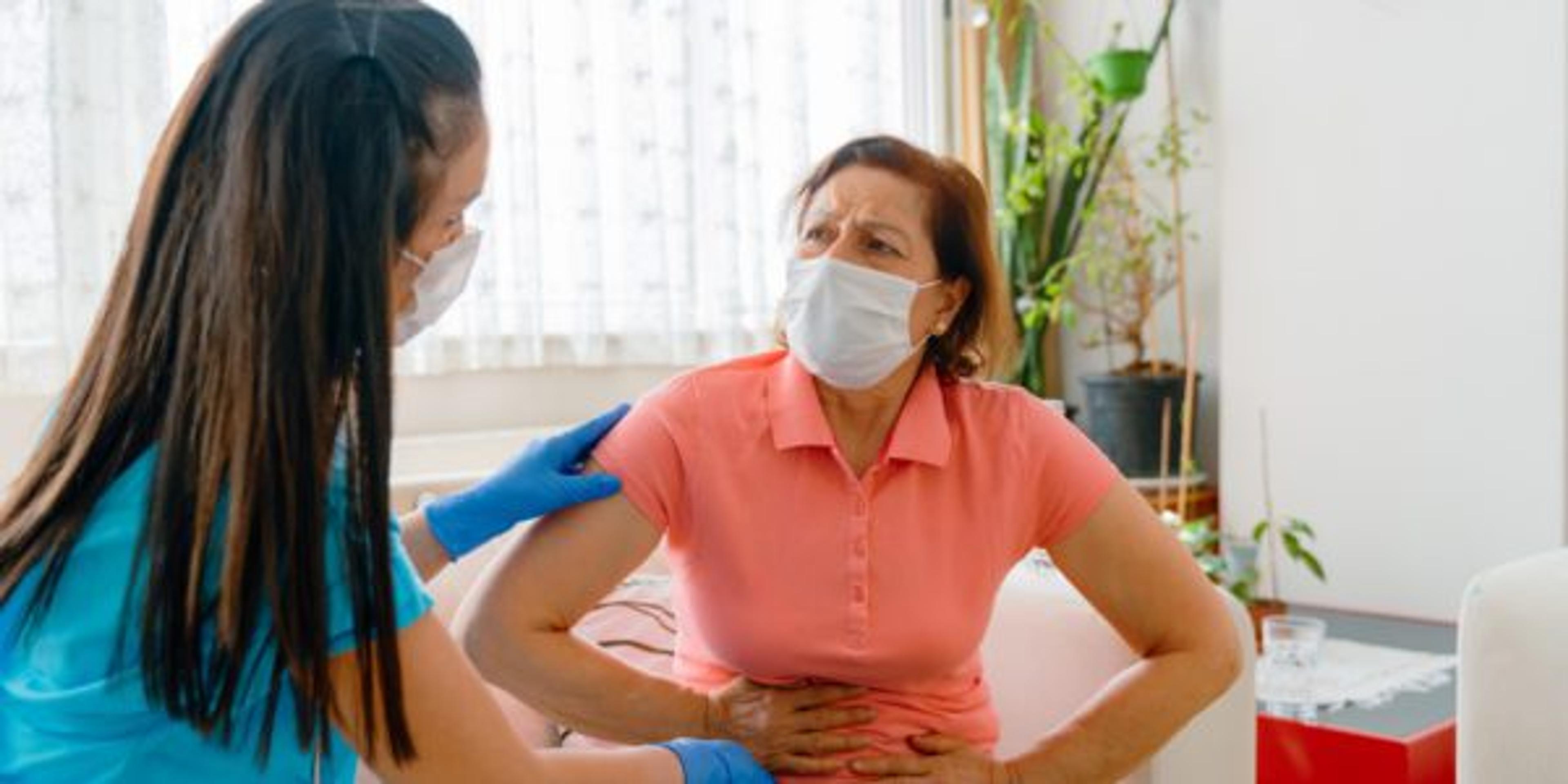 Abdominal pain patient woman having medical exam with doctor on illness from stomach cancer, irritable bowel syndrome, pelvic discomfort, Indigestion, Diarrhea, GERD (gastro-esophageal reflux disease)