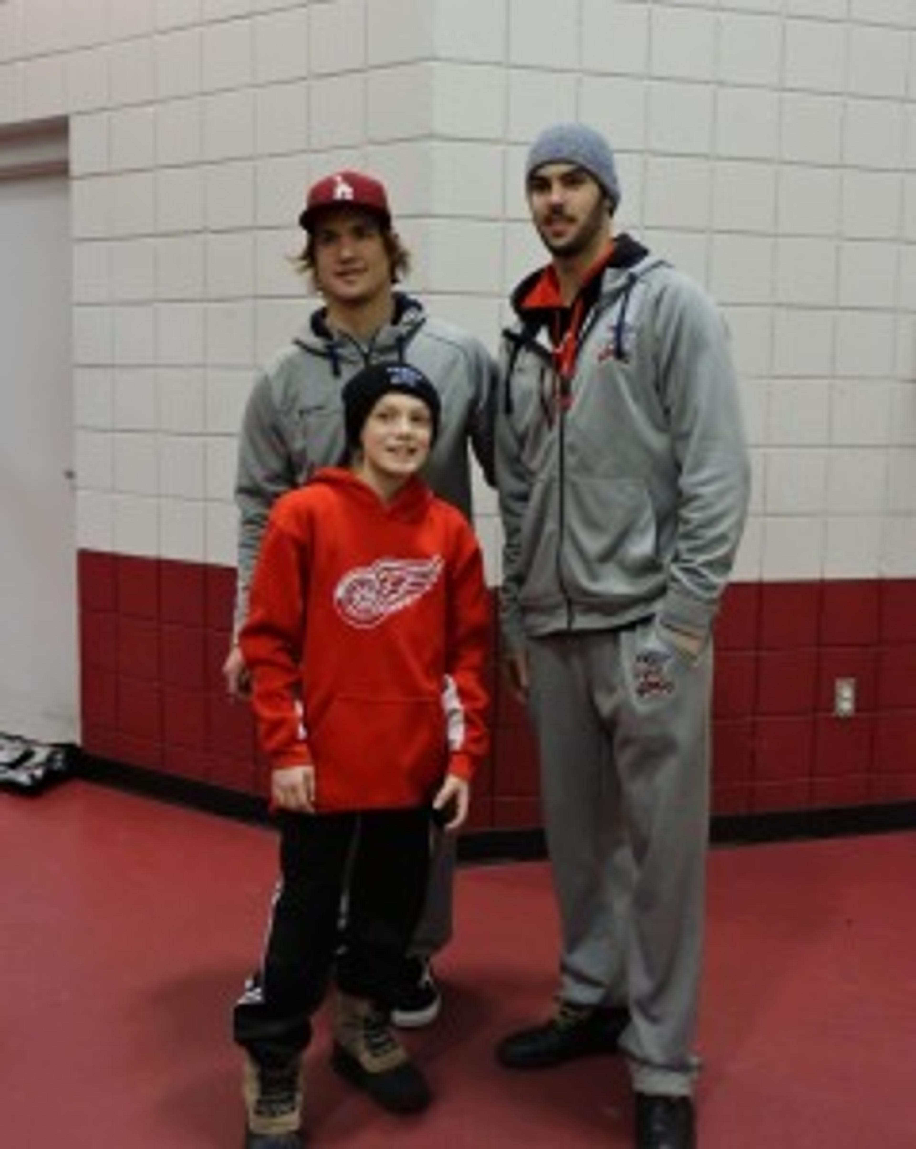 Mitch Callahan and Ryan Sproul pose for a picture with 11-year-old fan Avery Olenzuk. 