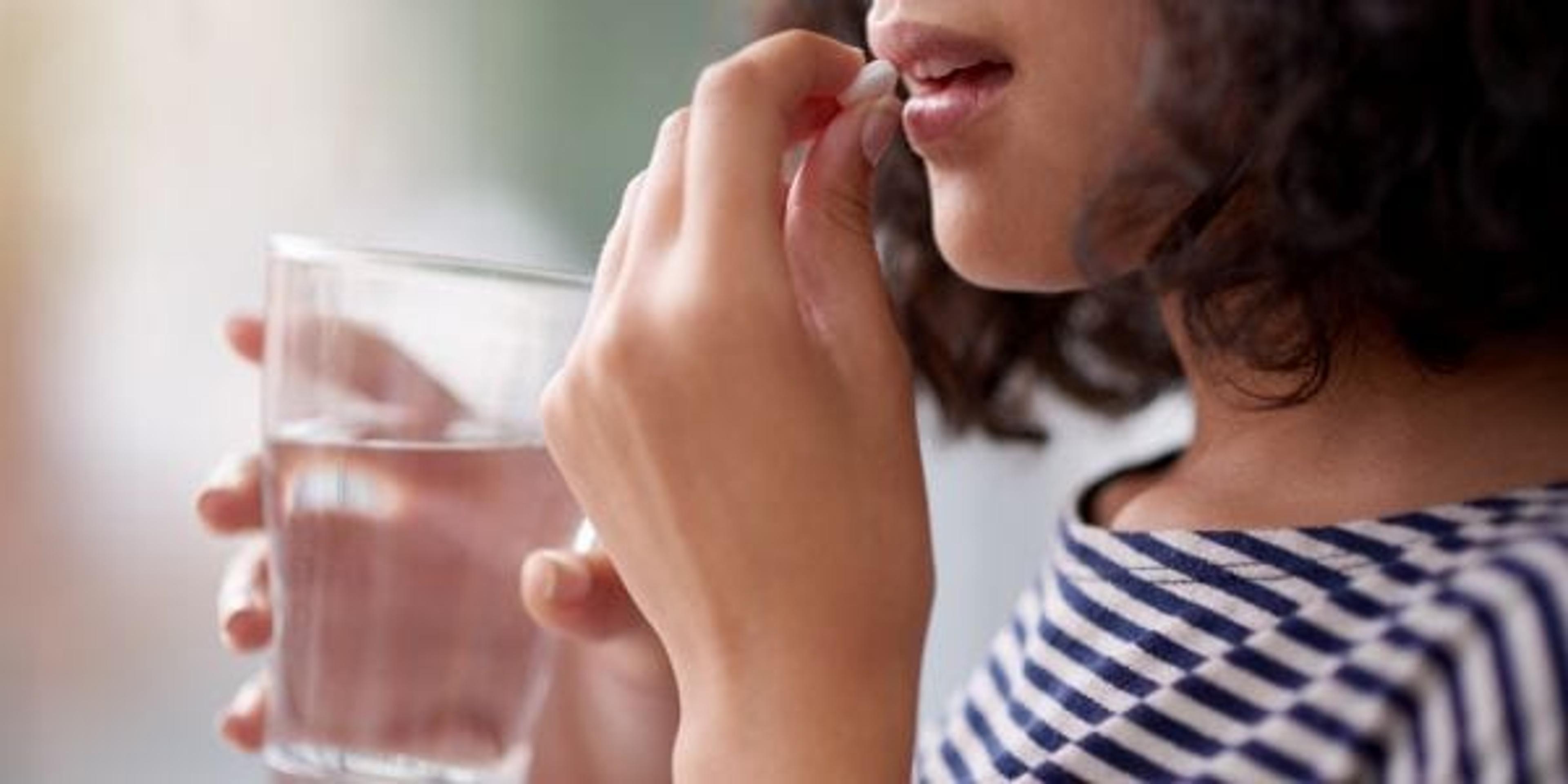 Woman taking a vitamin