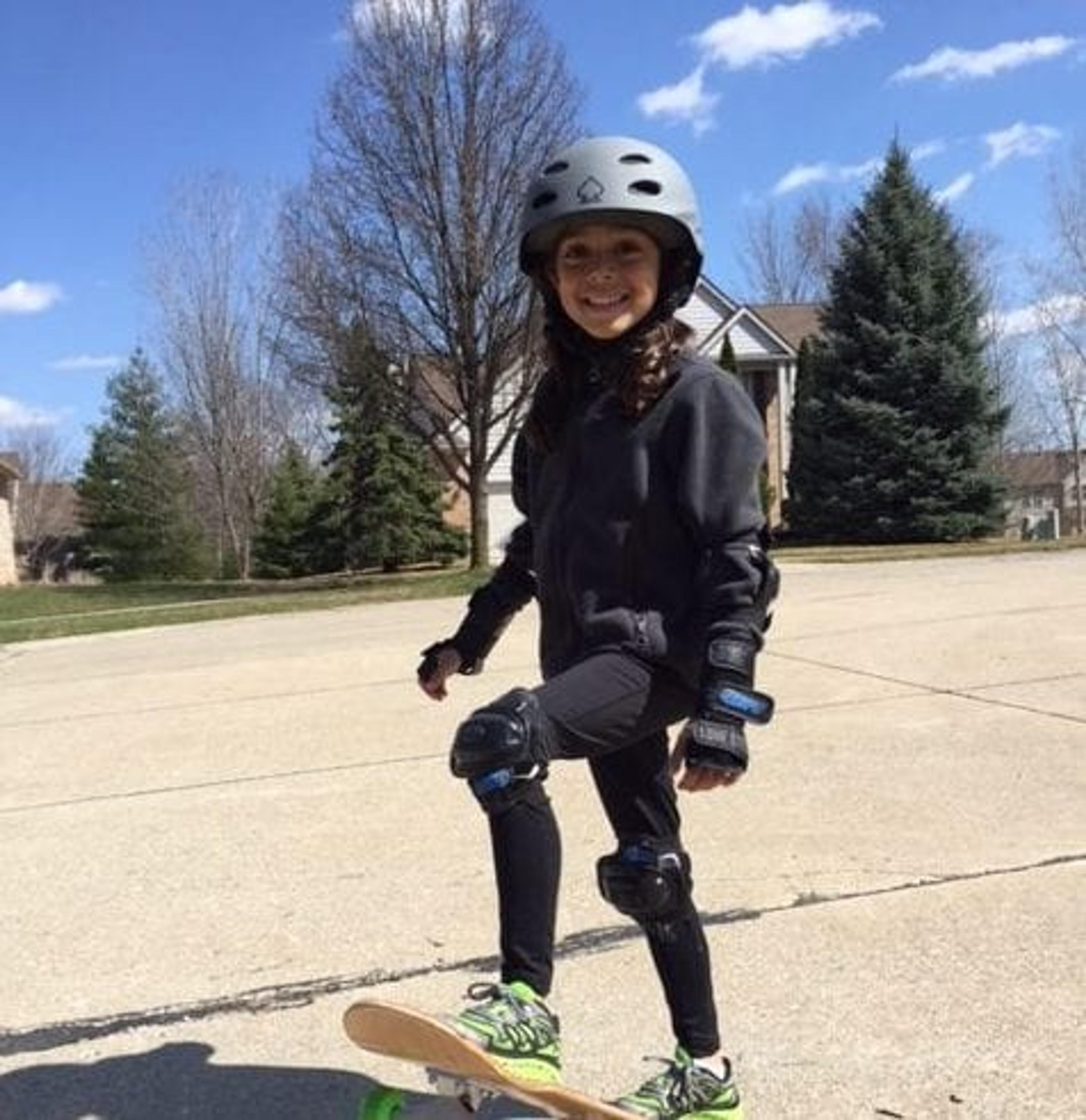 Naiya wearing a helmet skateboarding
