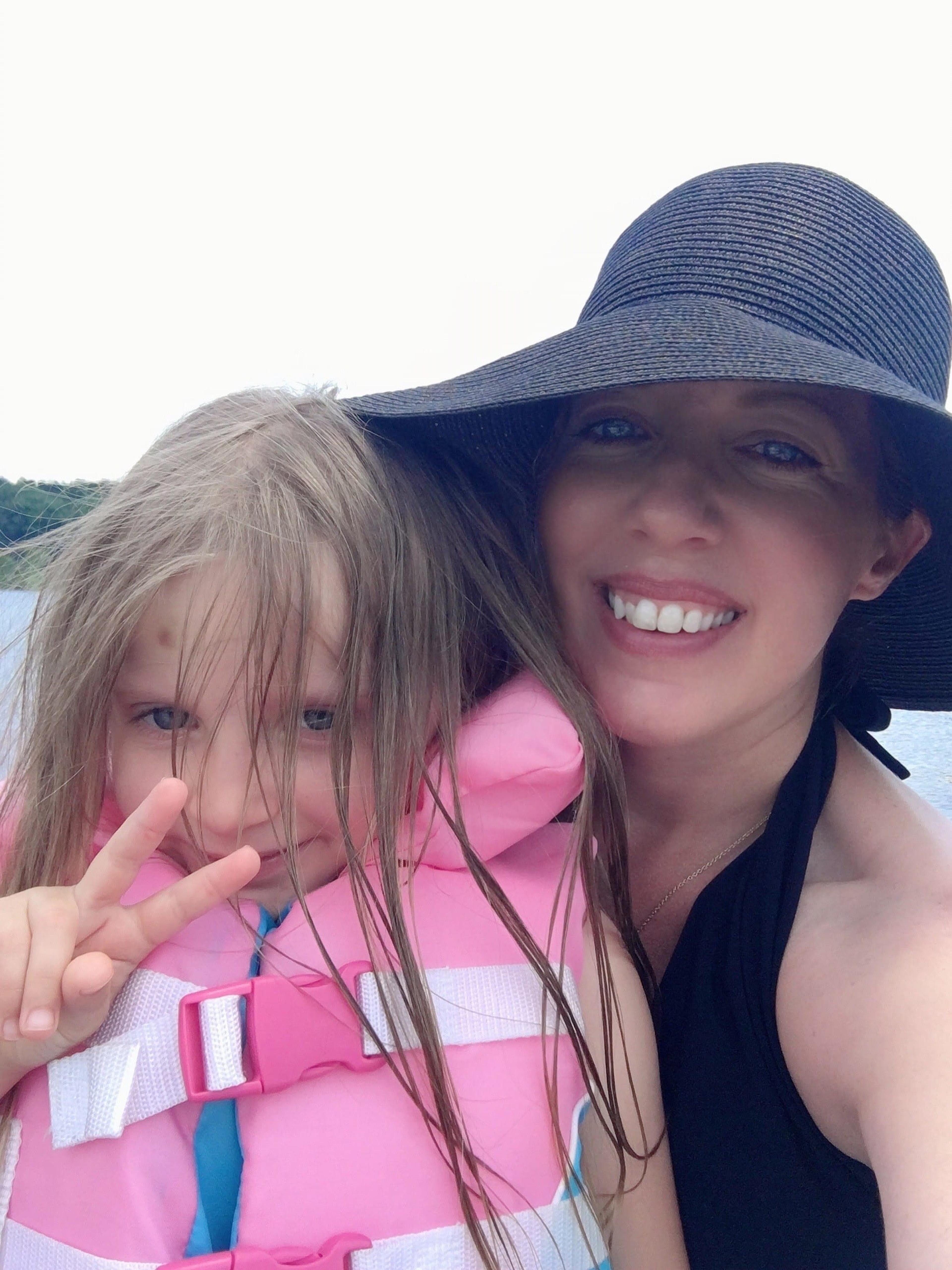 The author in a summer hat with her daughter