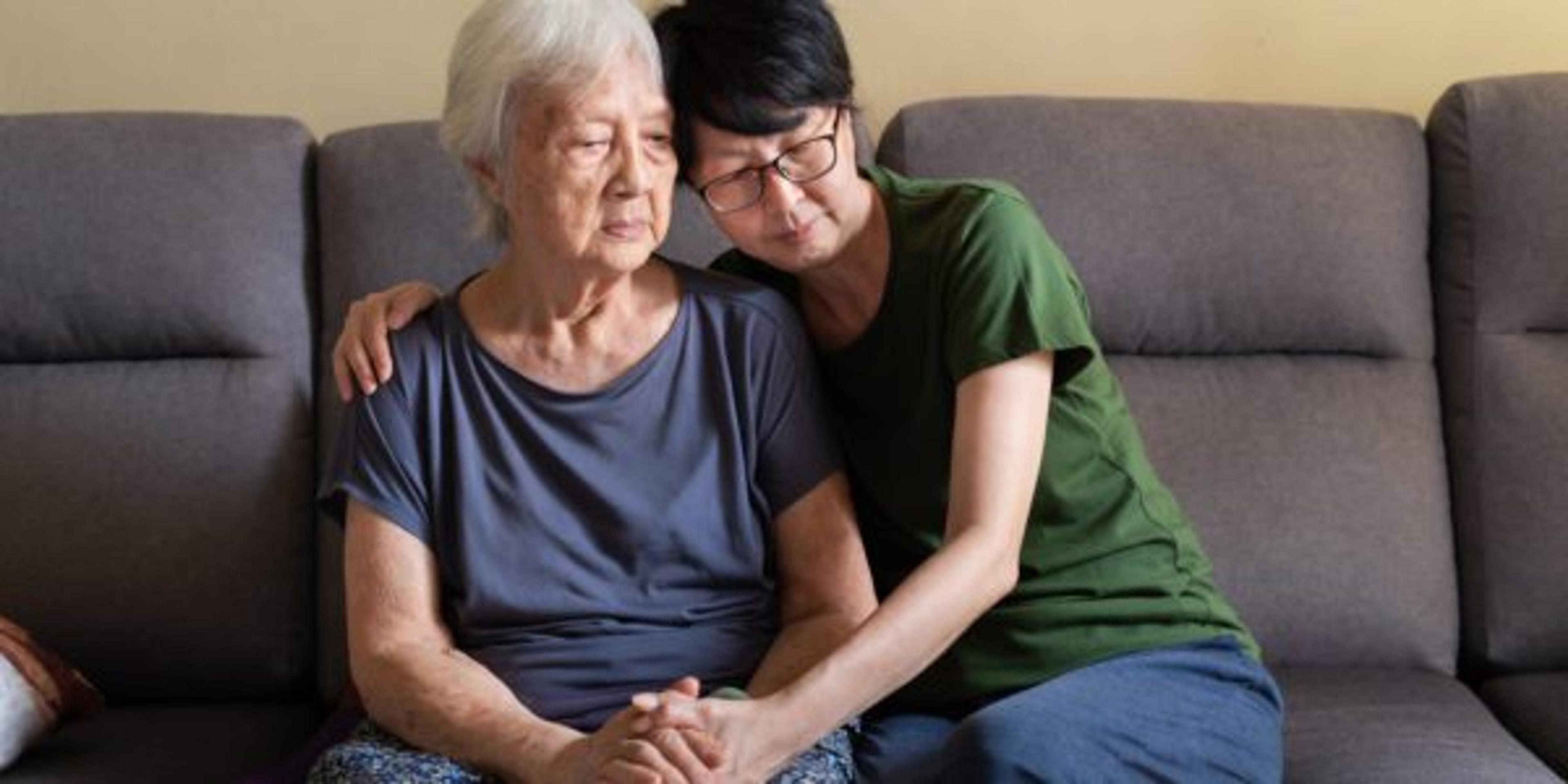 Asian daughter spending time with her elderly mother at home