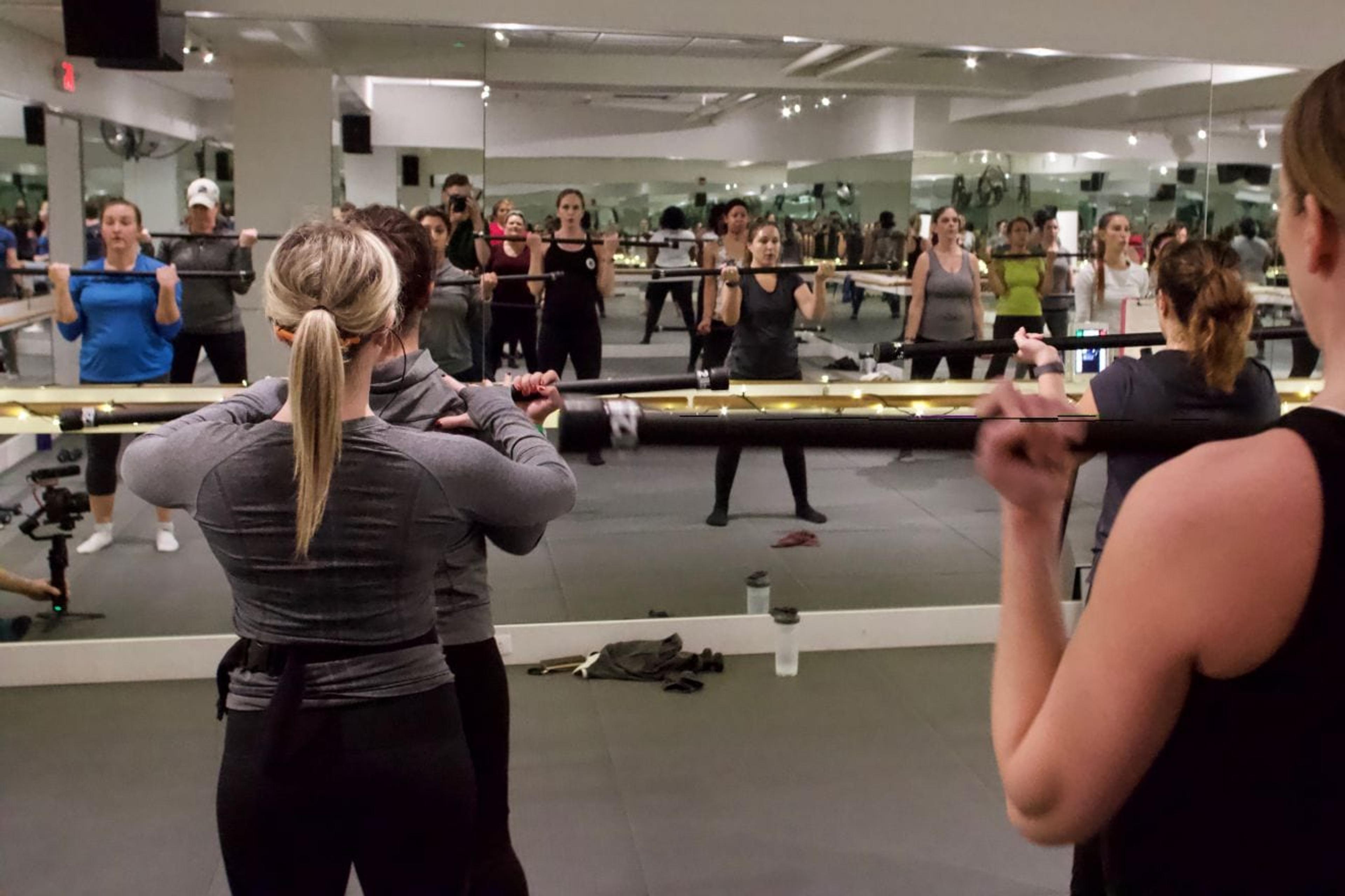 Class participants checking their form in a mirror.