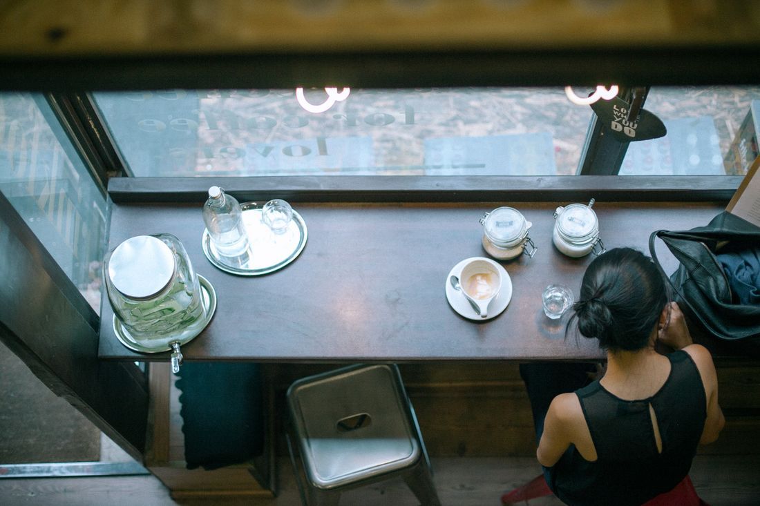 A woman sitting alone at a café counter