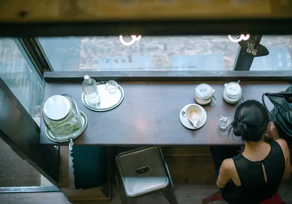 A woman sitting alone at a café counter