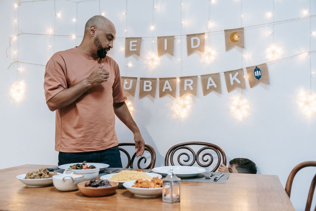 A father preparing an Eid celebration with his child
