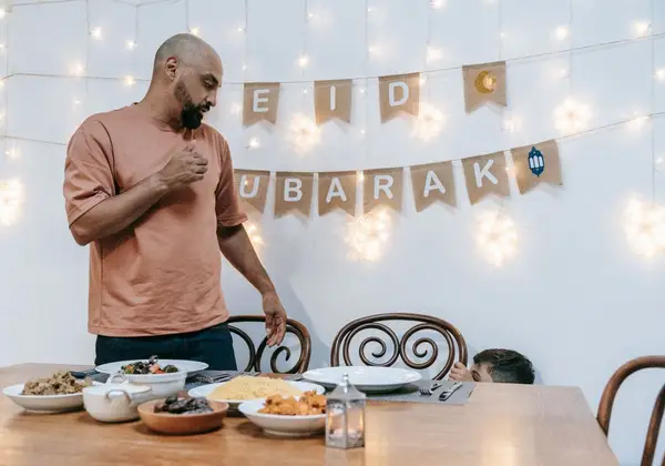 A father preparing an Eid celebration with his child