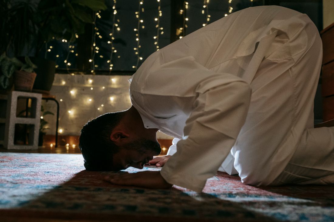 A man in prayer at home in the quiet of the evening