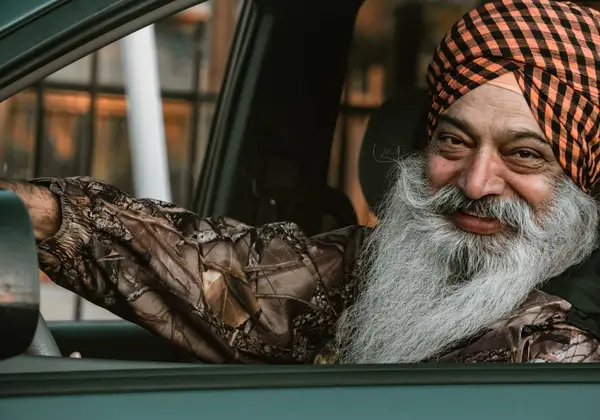 An older man with a flowing beard, smiling warmly